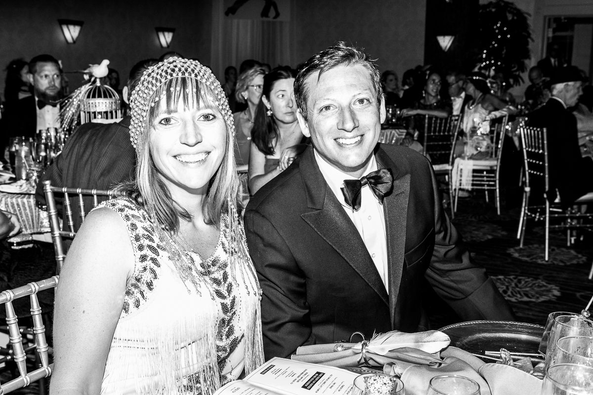 A man and a woman are sitting at a table in a black and white photo.