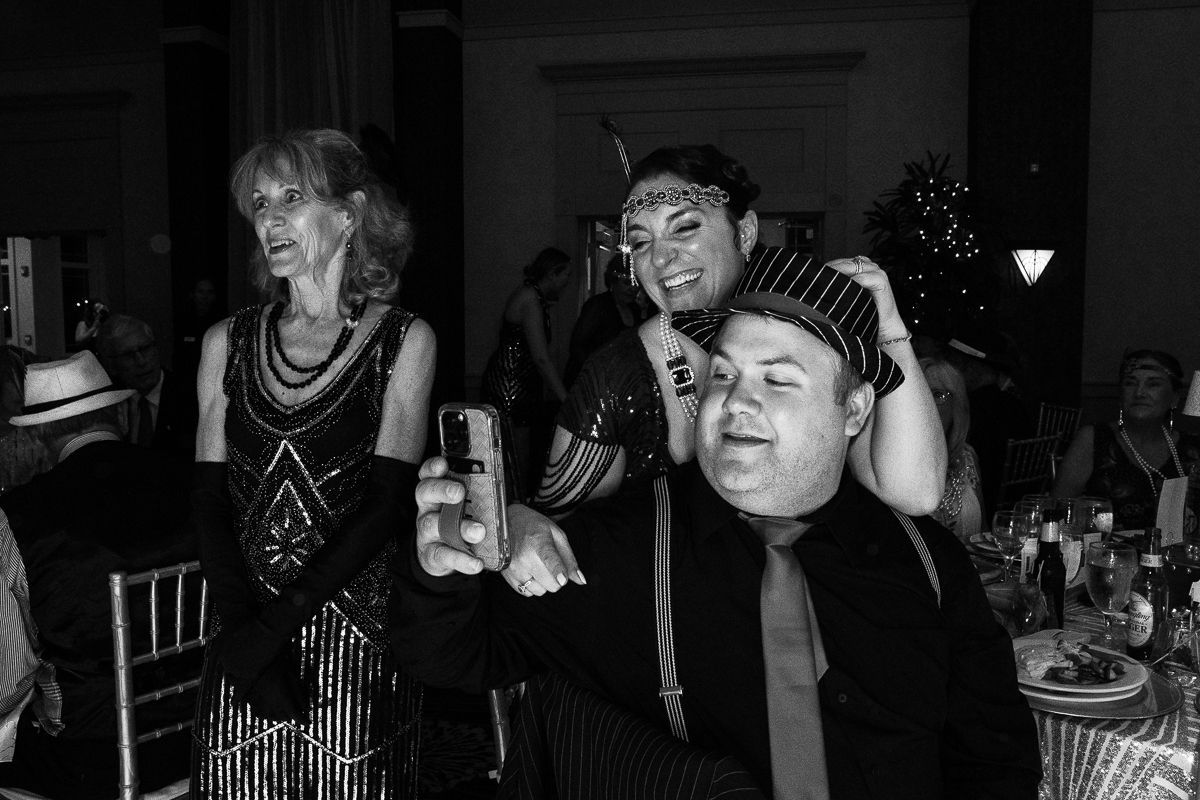 A man is taking a selfie with a woman at a party.