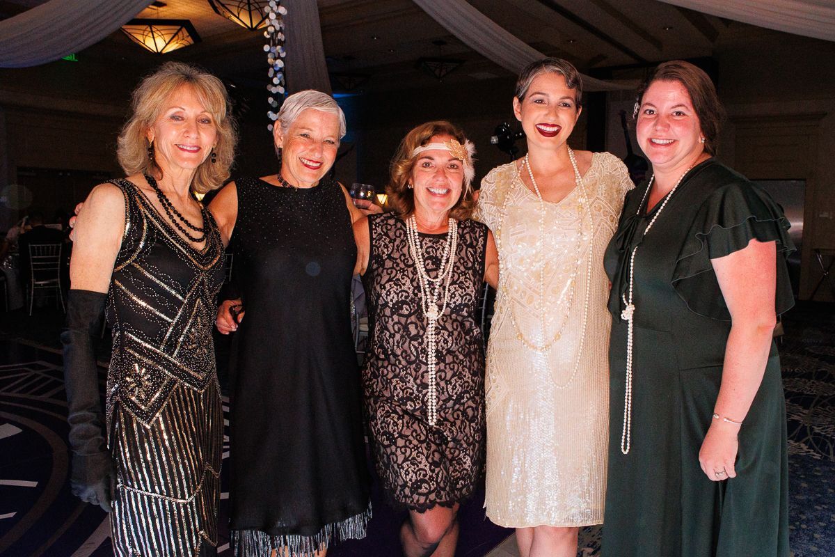 A group of women are posing for a picture together.