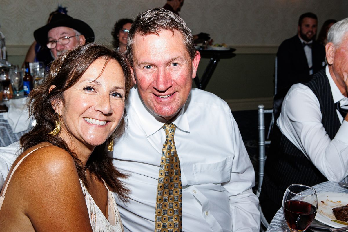 A man and a woman are posing for a picture at a party