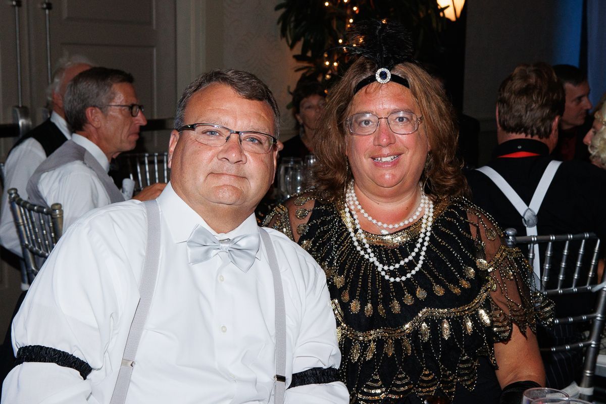 A man and a woman are posing for a picture at a party.