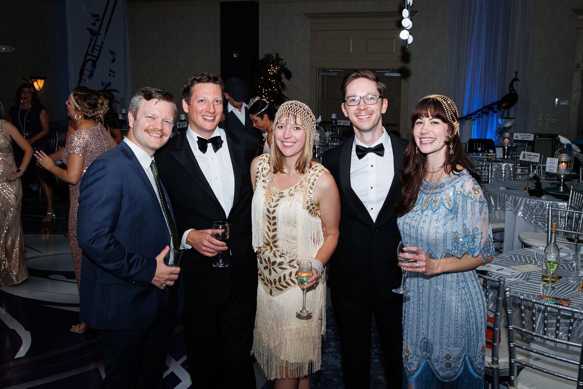 A group of people are posing for a picture at a party.
