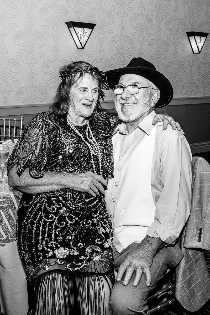 A man and a woman are posing for a picture in a black and white photo.