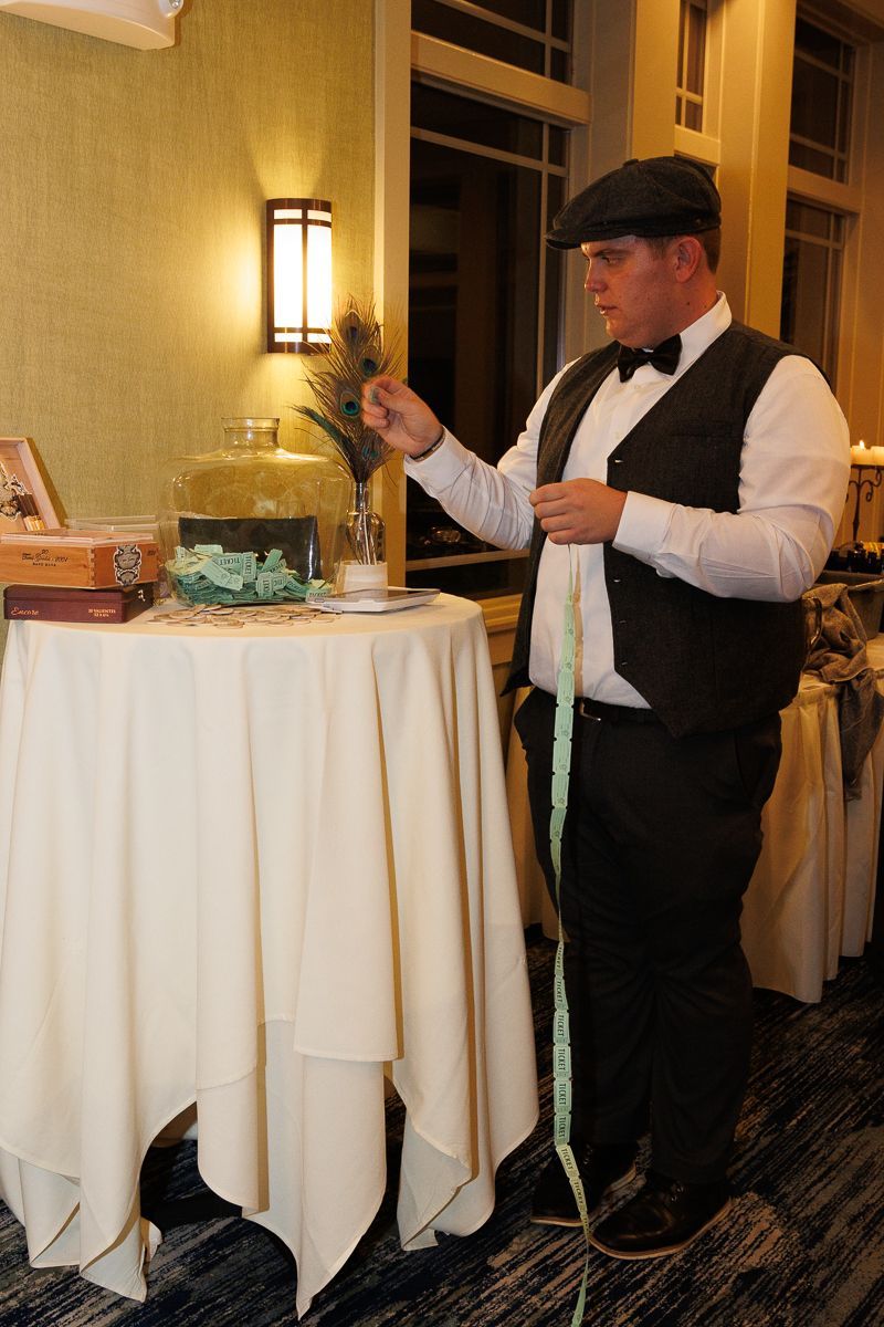 A man in a tuxedo is measuring something with a tape measure