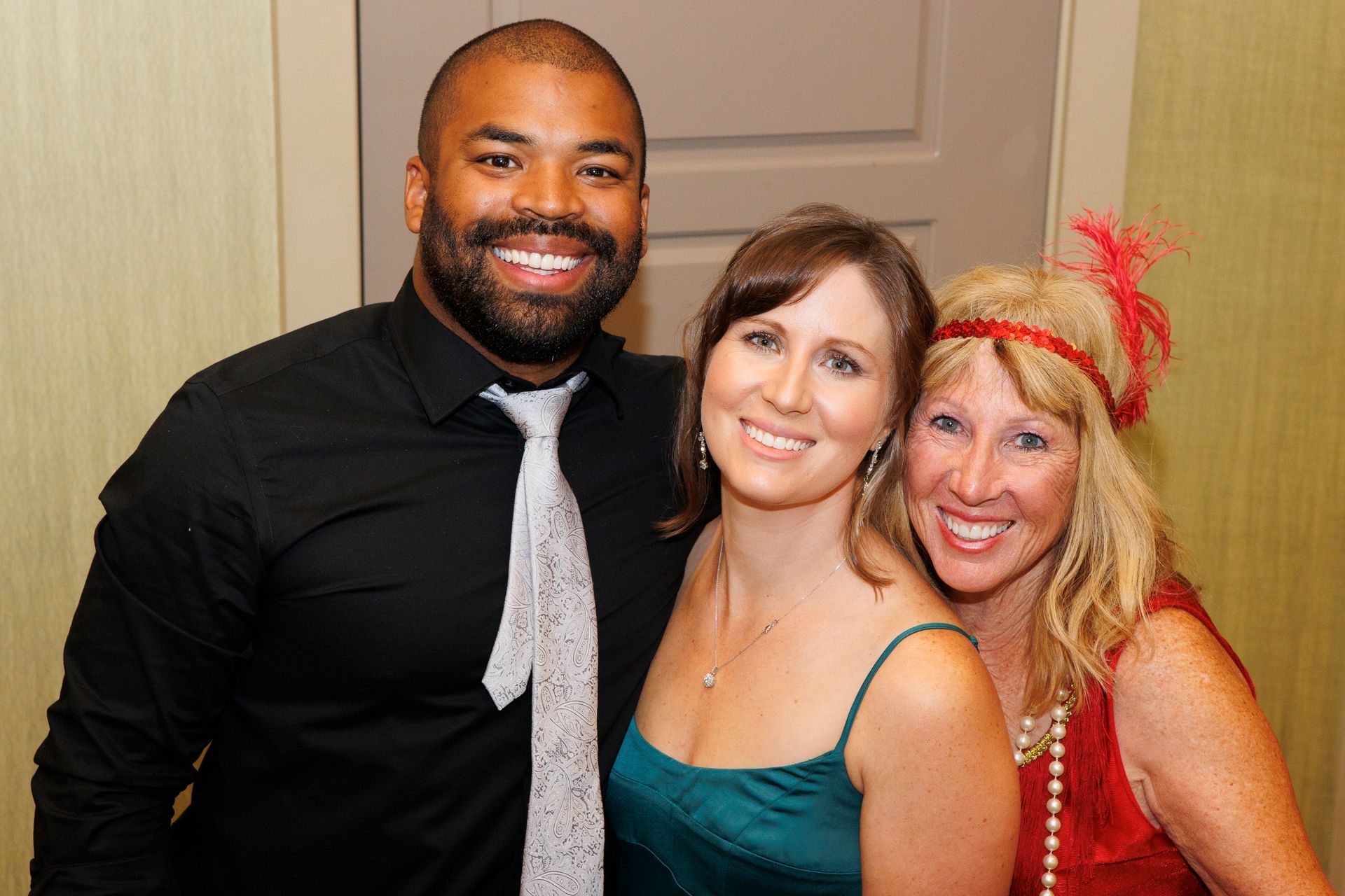 A man and two women are posing for a picture together