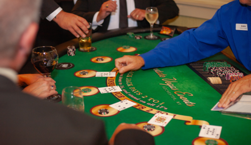 A group of people are playing a game of blackjack at a table.
