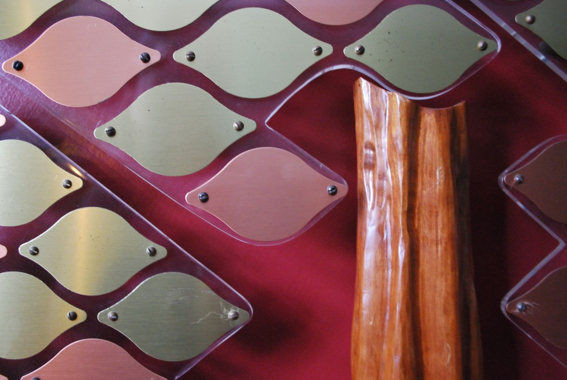 A close up of a plaque with a wooden handle