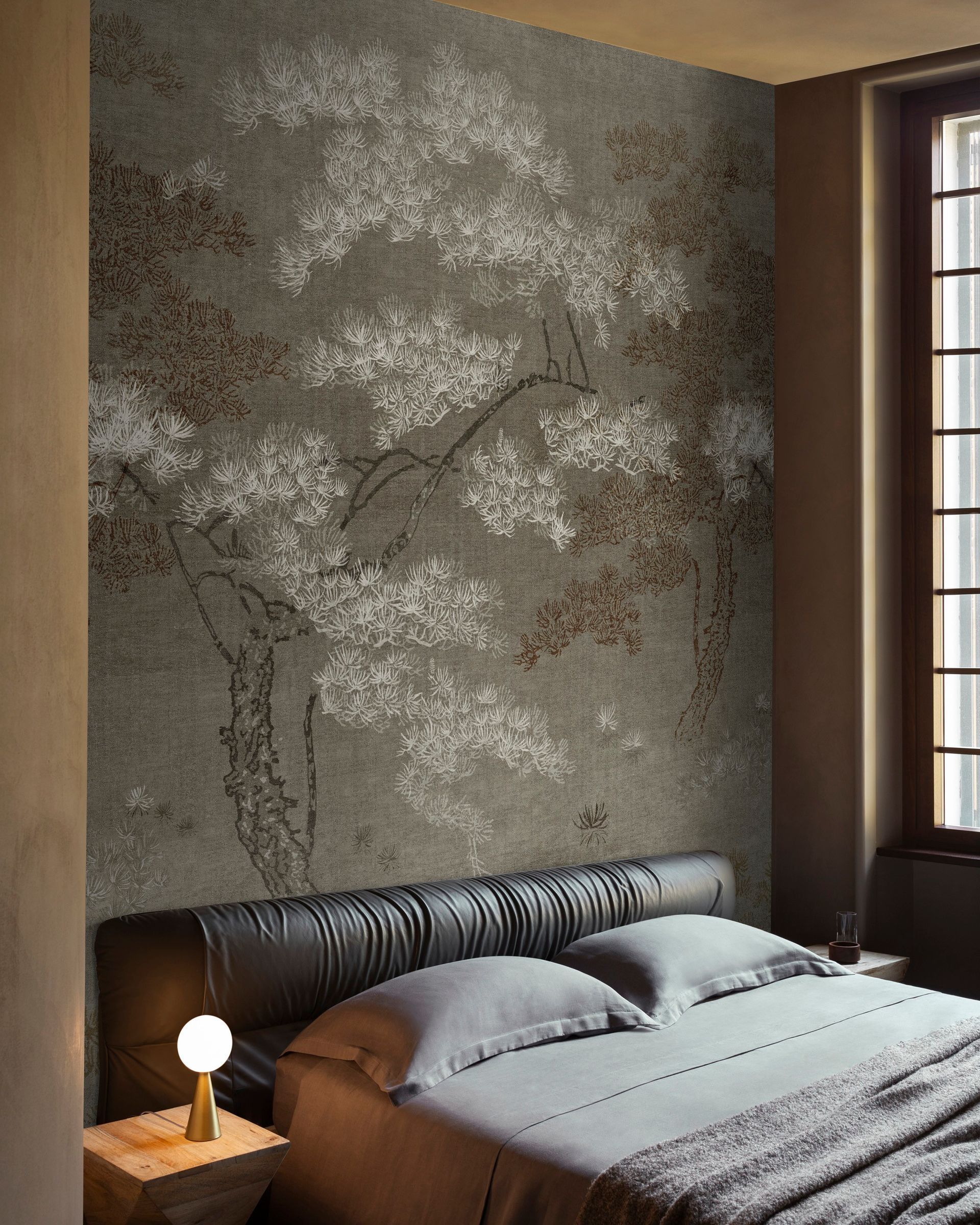 Una camera da letto con un letto e una parete con un albero sopra