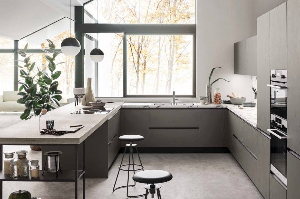 Una cucina con molti mobili e una grande finestra.