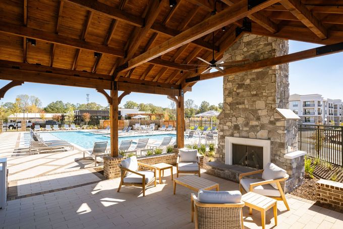 An artist 's impression of a building with cars parked in front of it.