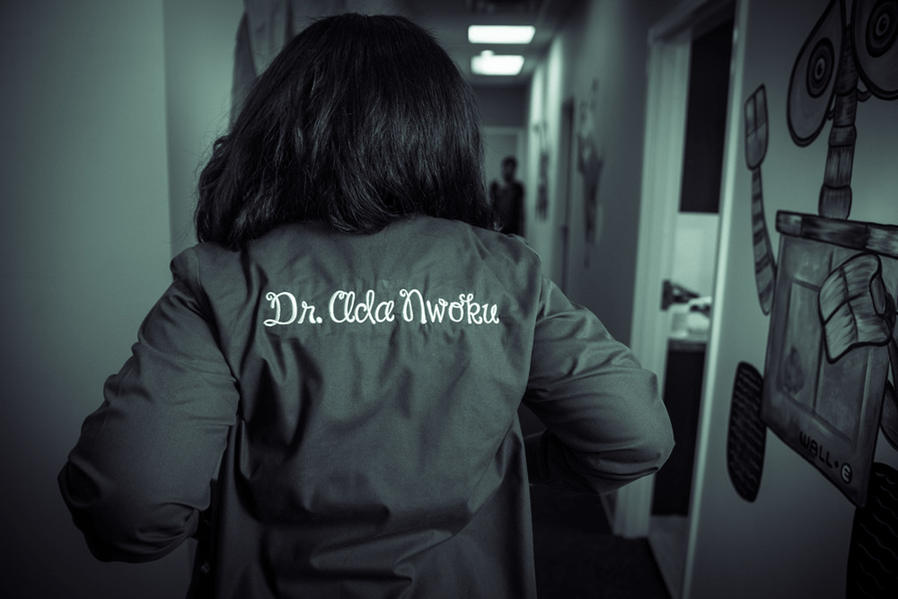 Dr. Ada Nwoku showing scrubs with her name stitched on the back