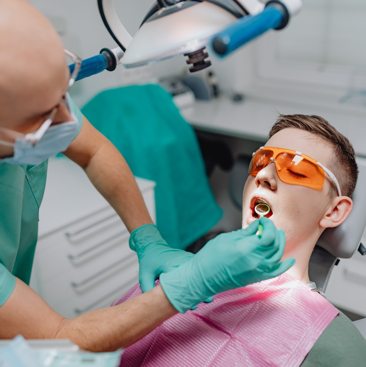 A patient is being treated by a dentist.