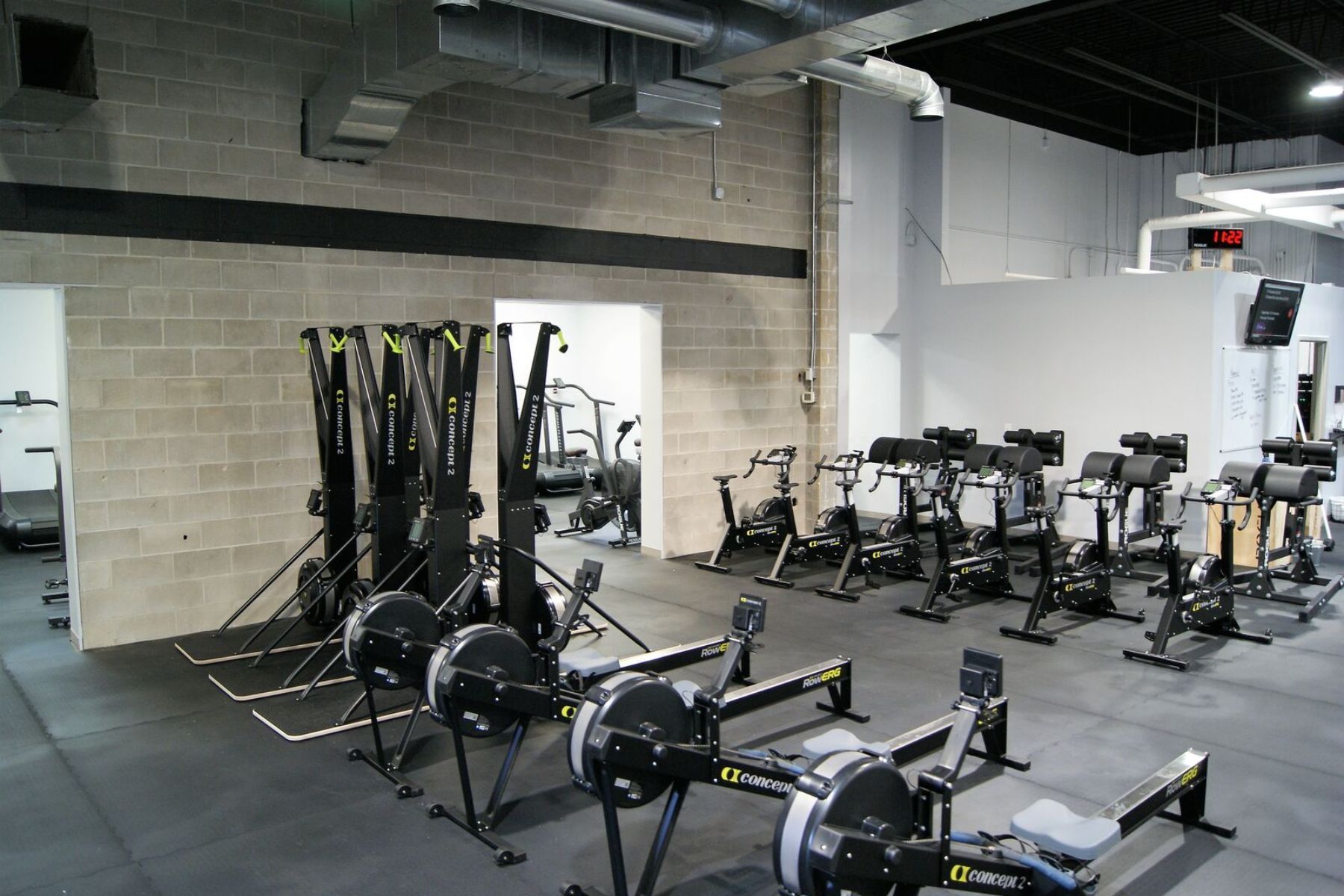 A gym with a lot of exercise equipment on the floor