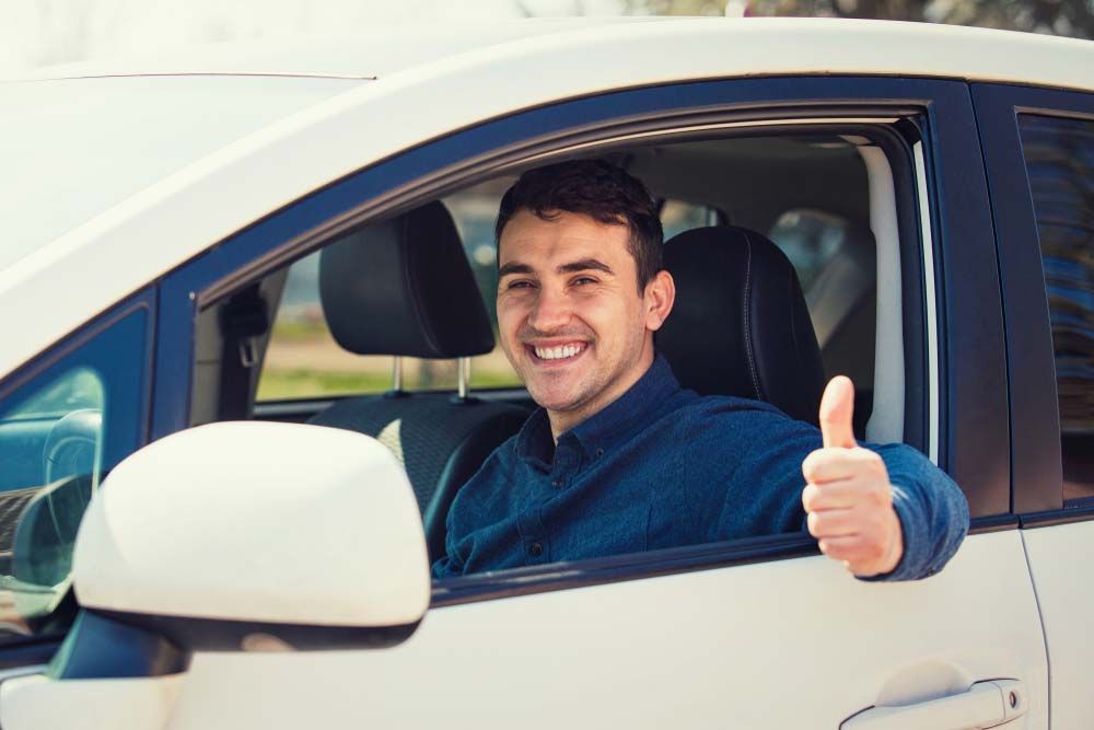 Happy Guy With Thumbs Up Driving A Car