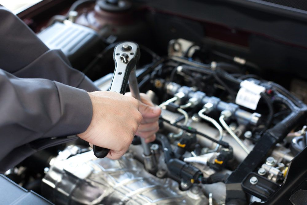 Mechanic Checking Engine Of A Car