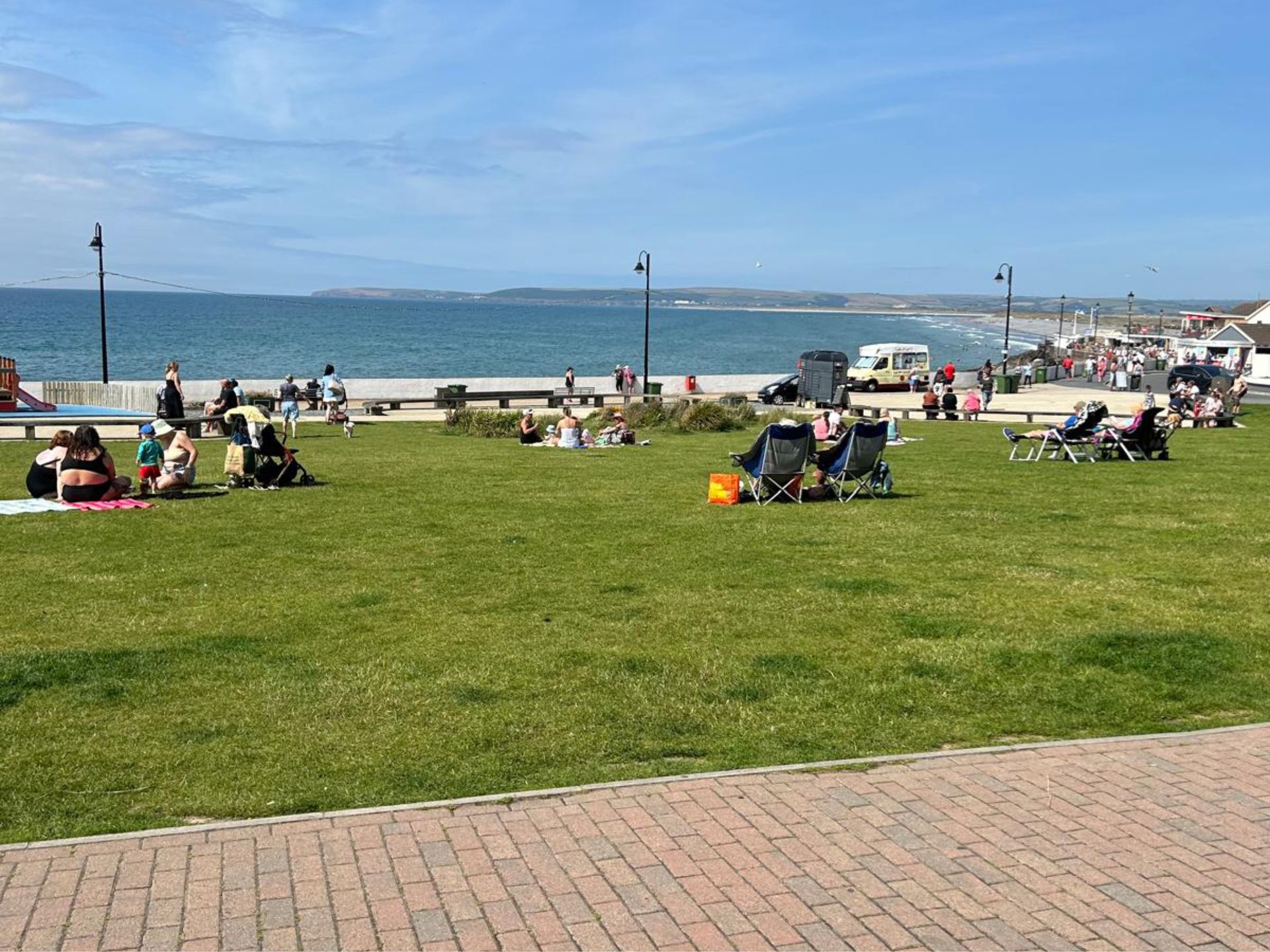 Westward Ho! village green with beach in the background