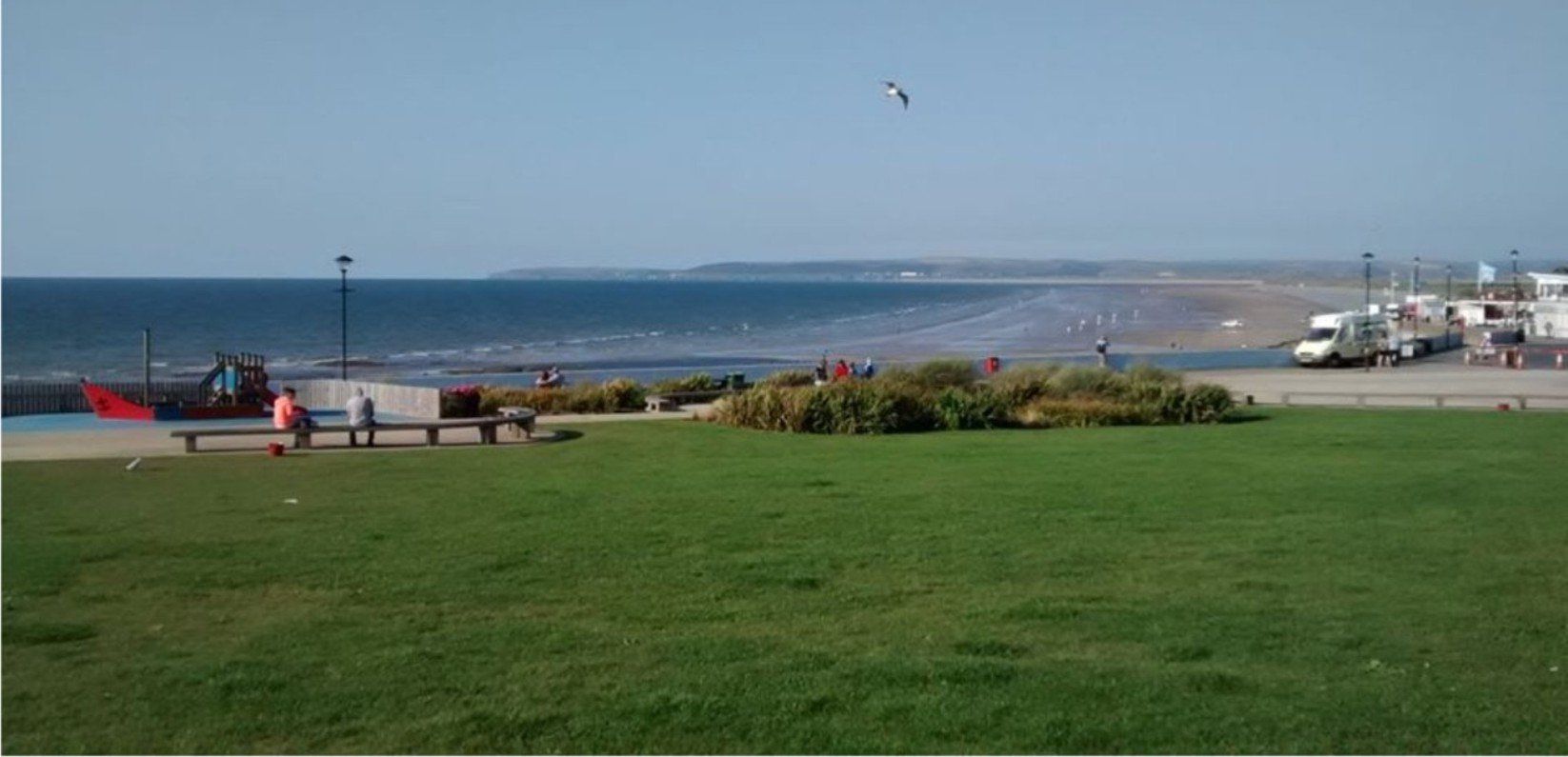 Westward Ho! village green with beach in the background