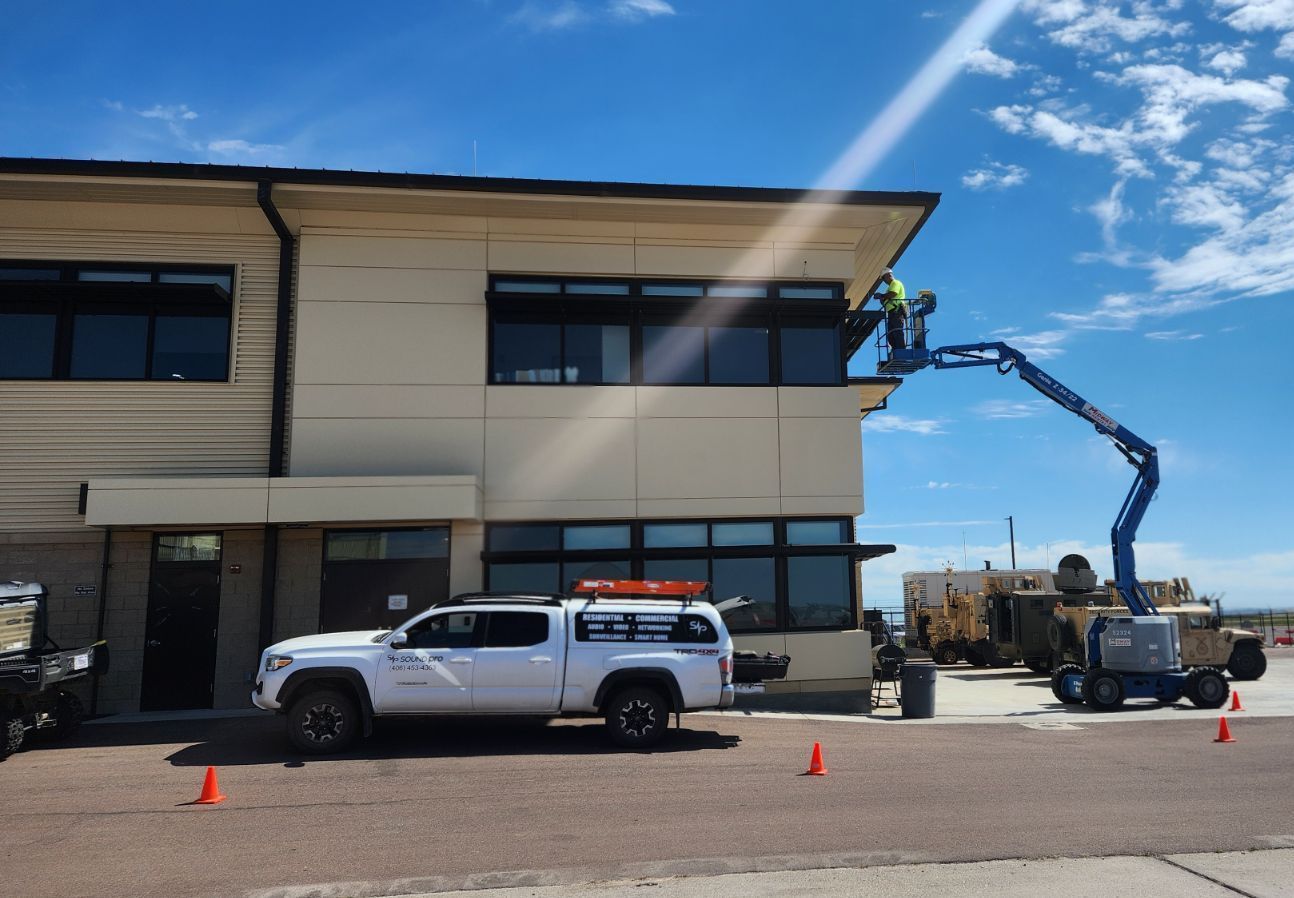 A white truck is parked in front of a building