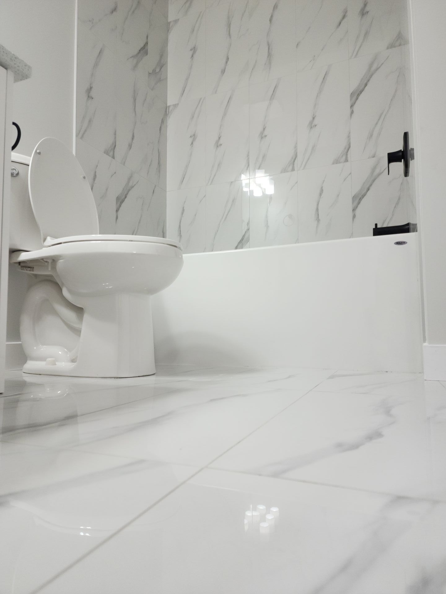 picture of a Toilet and Tub in a bathroom in a basement development 