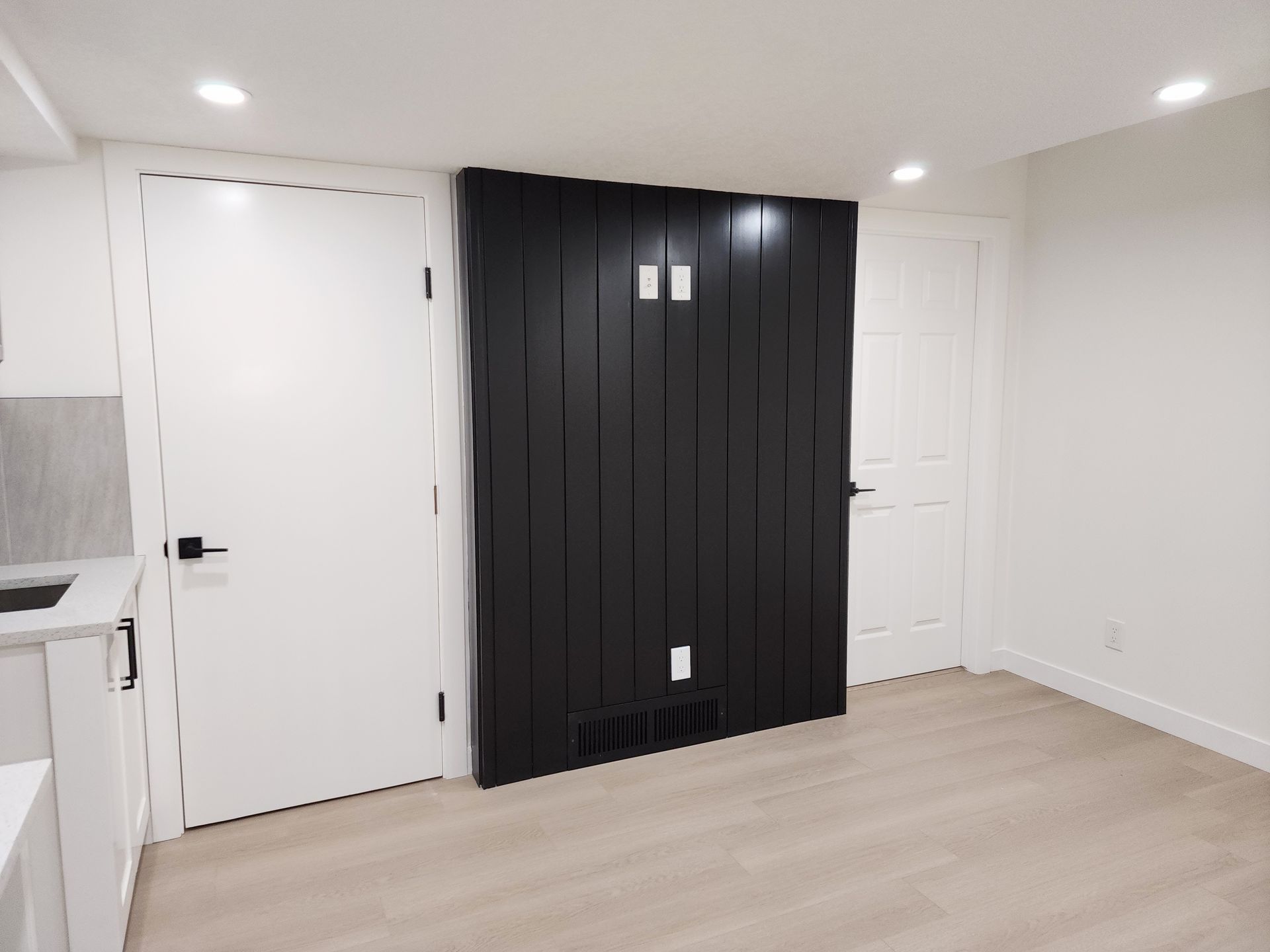 picture show a black ship-lap feature wall in a finished basement development near me