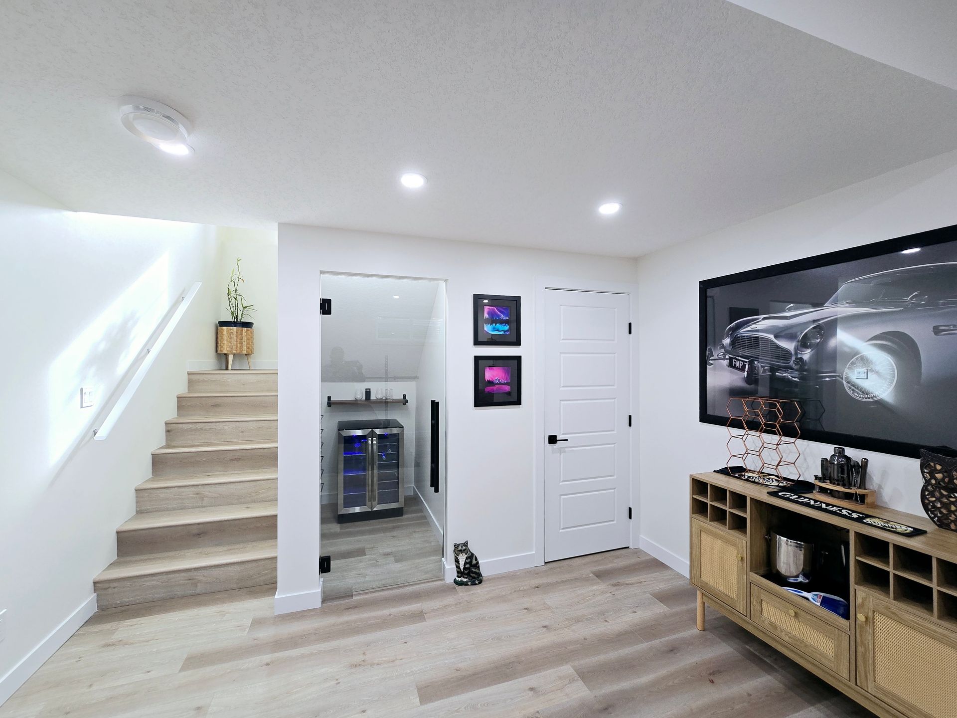 image depicts a door leading to a 3 piece bathroom showing a shower with glass sliding door, a toilet and a custom vanity