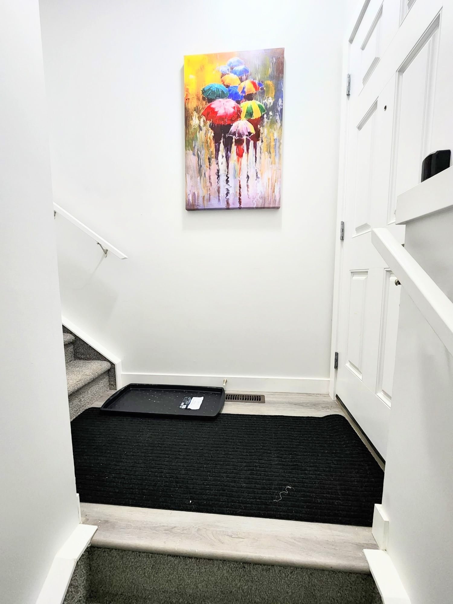 This image shows a painting on the wall at a stairs landing in a basement renovation in Calgary Alberta