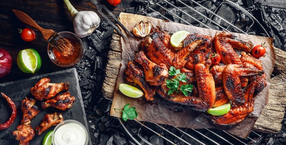 Grilled Chicken Wings on A Wooden Board — Romanas Italian Restaurant in Nobby Beach, QLD