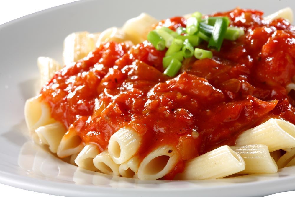 Pasta with Red Tomato Sauce and Green Onion Garnish — Romanas Italian Restaurant in Nobby Beach, QLD