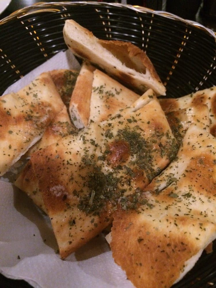 There are many different types of food on the table — Romanas Italian Restaurant in Nobby Beach, QLD