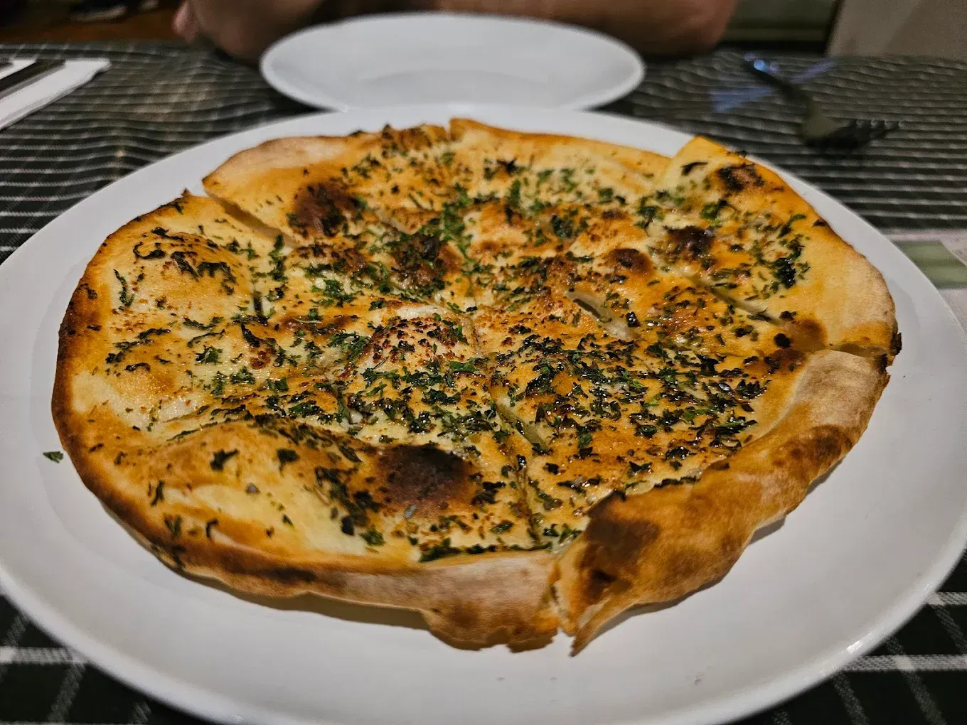 A White Plate Topped With a Loaf of Bread and Dipping Sauces — Romanas Italian Restaurant in Nobby Beach, QLD