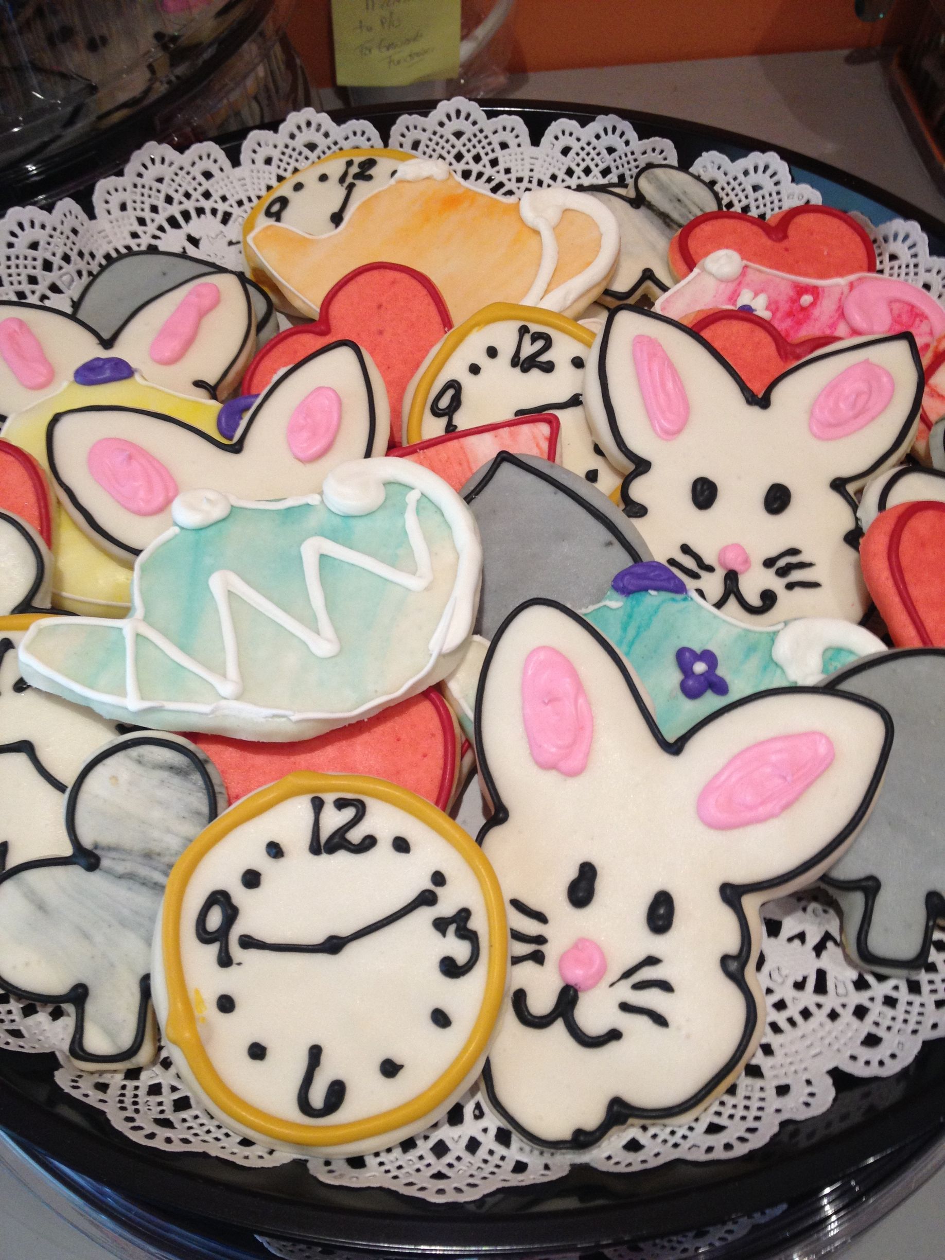 a tray of bunny shaped cookies with a clock that says 12 on it