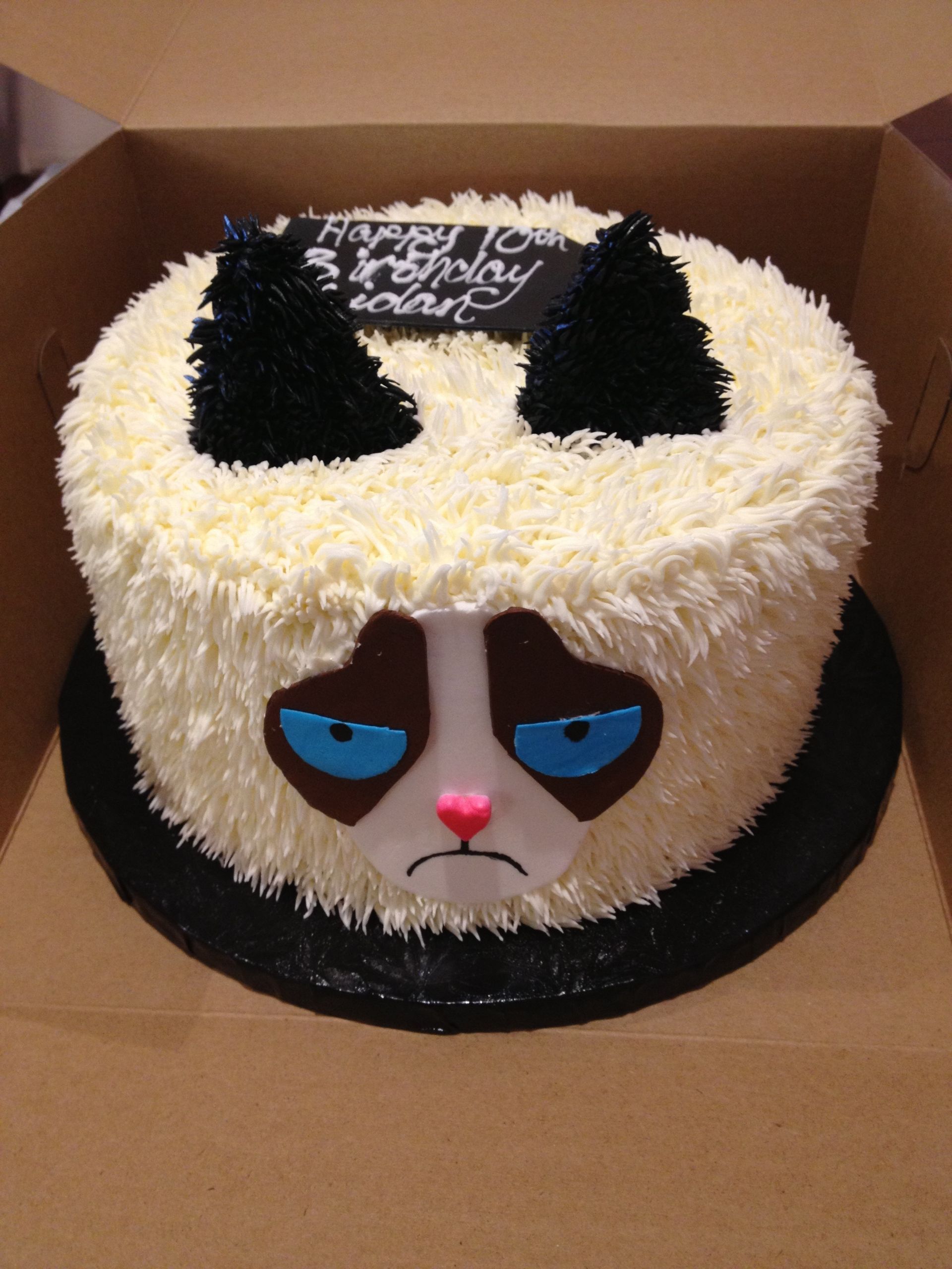a birthday cake with a grumpy cat face on it