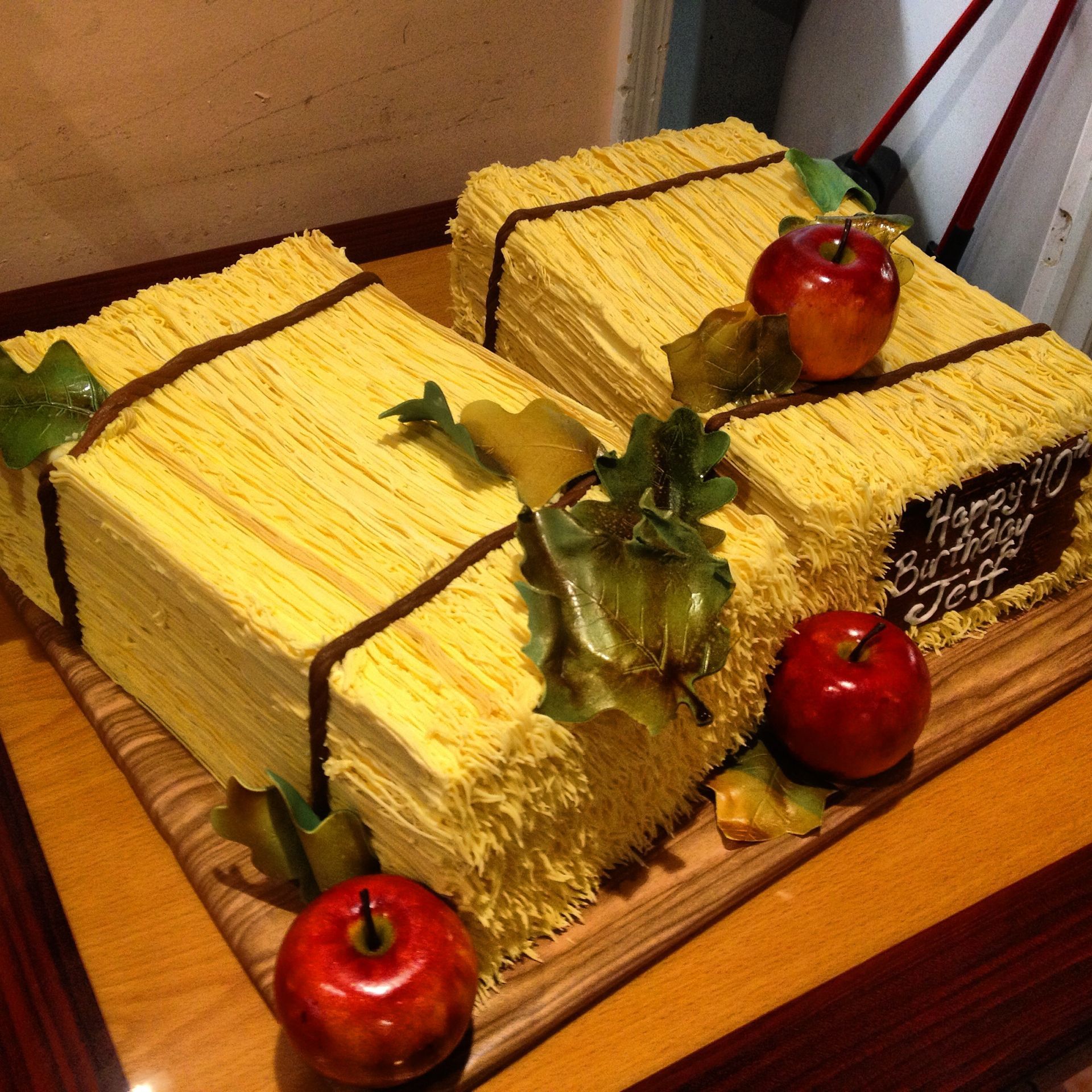 a cake that looks like hay bales with apples on top