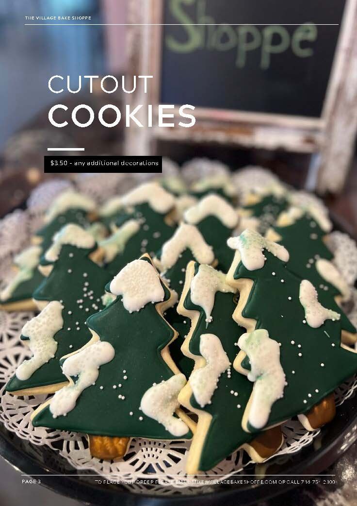 a plate of cutout cookies shaped like christmas trees