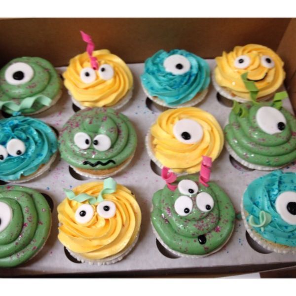 a box of cupcakes decorated to look like monsters