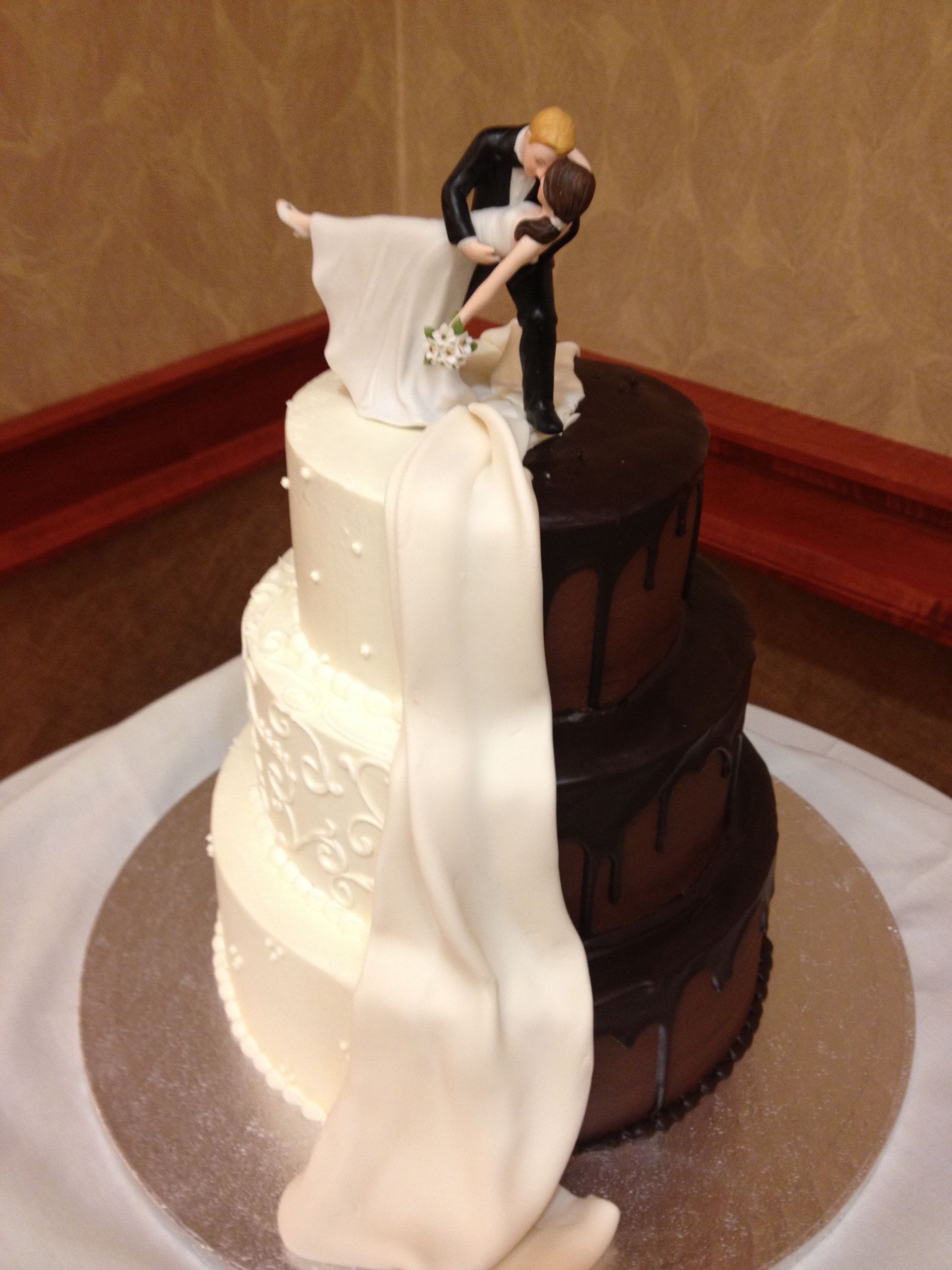 a wedding cake with a bride and groom figurine on top