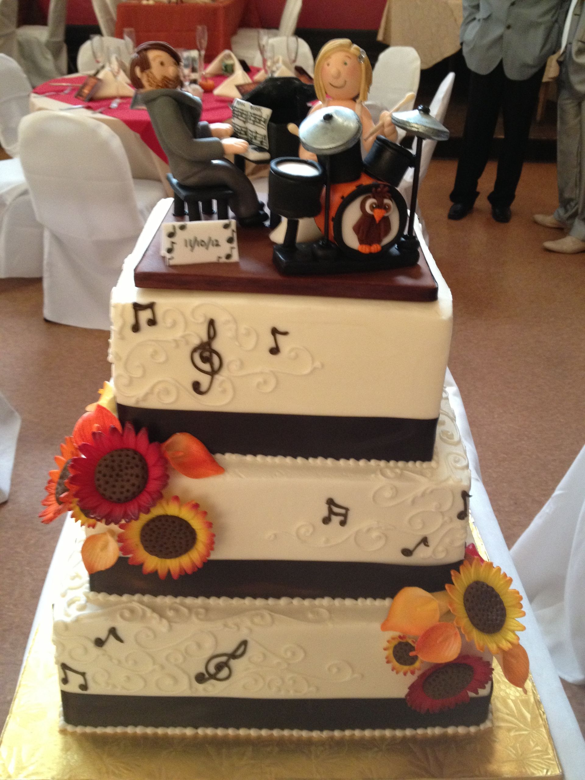 a wedding cake with a drummer on top of it