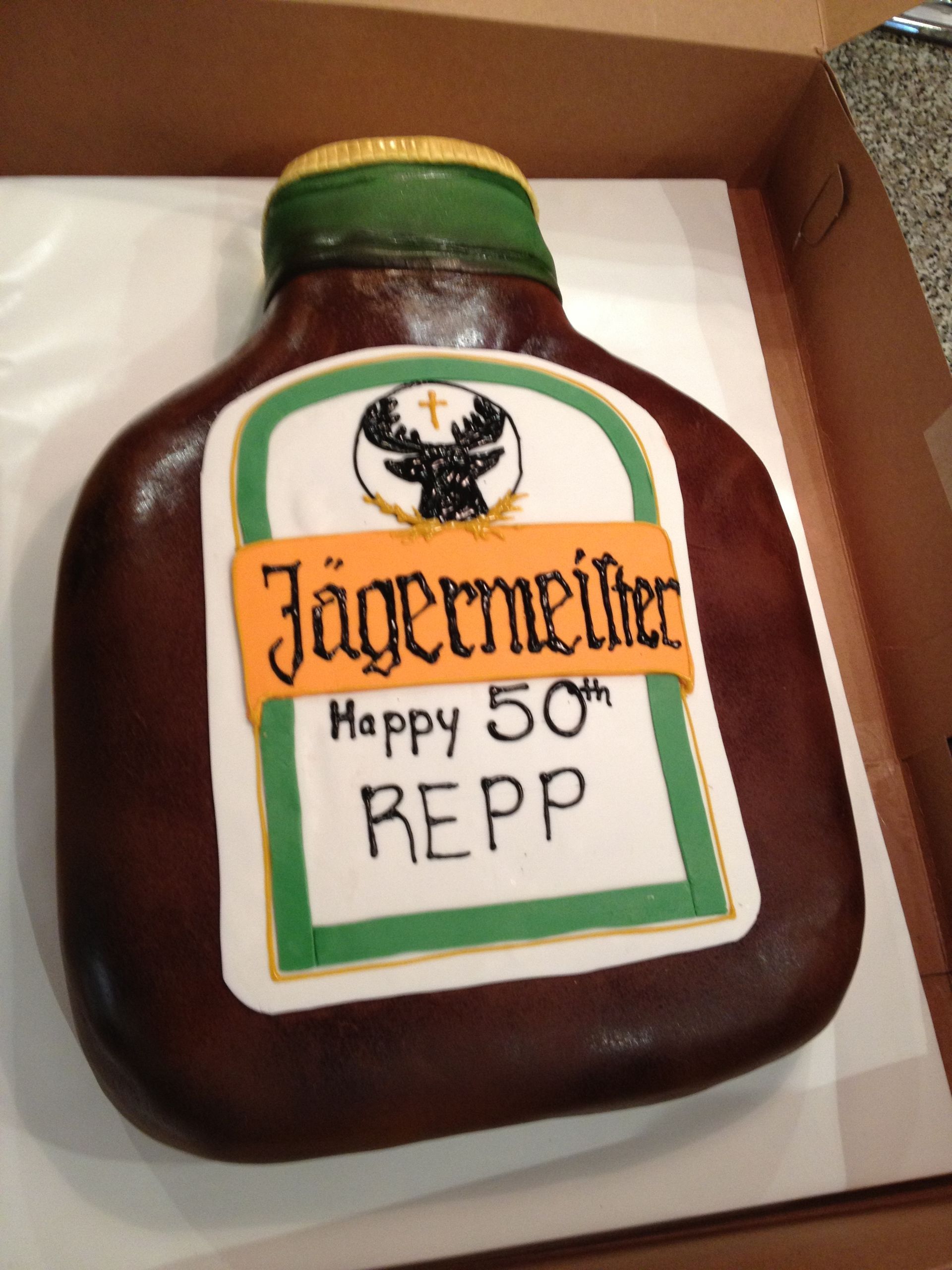 a cake in the shape of a bottle of jagermeister