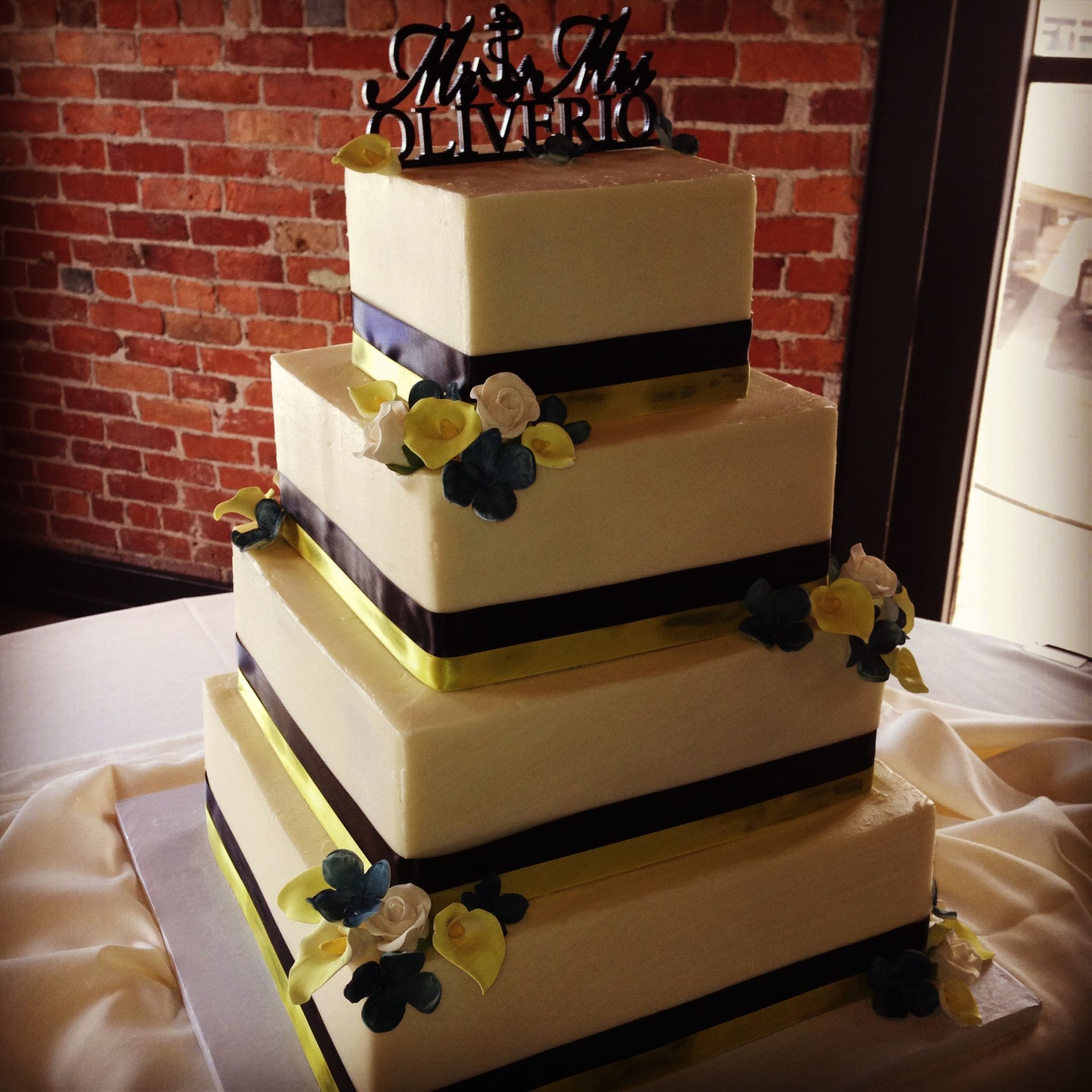 a wedding cake with the name olivia on top