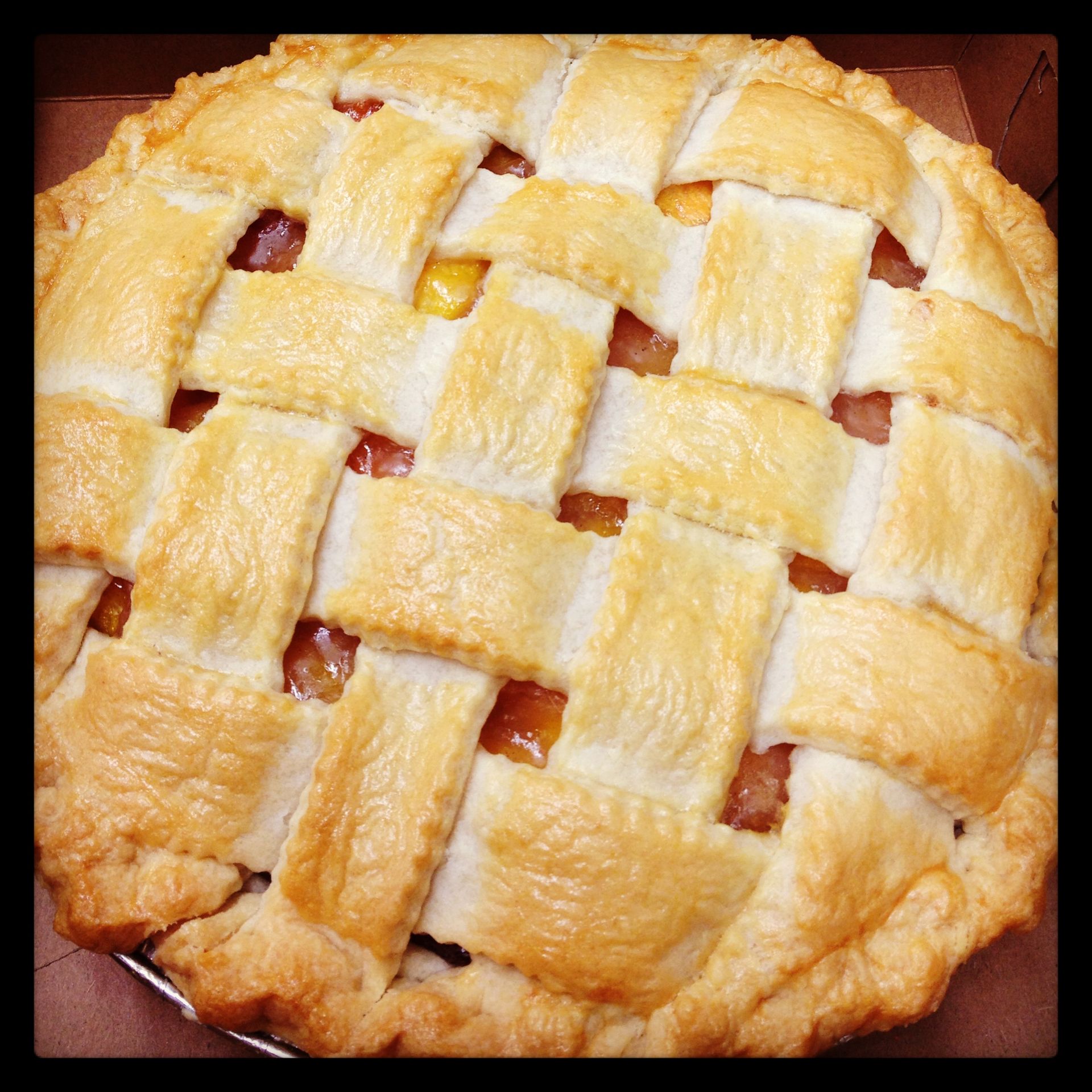 a pie with a lattice crust and a peach filling
