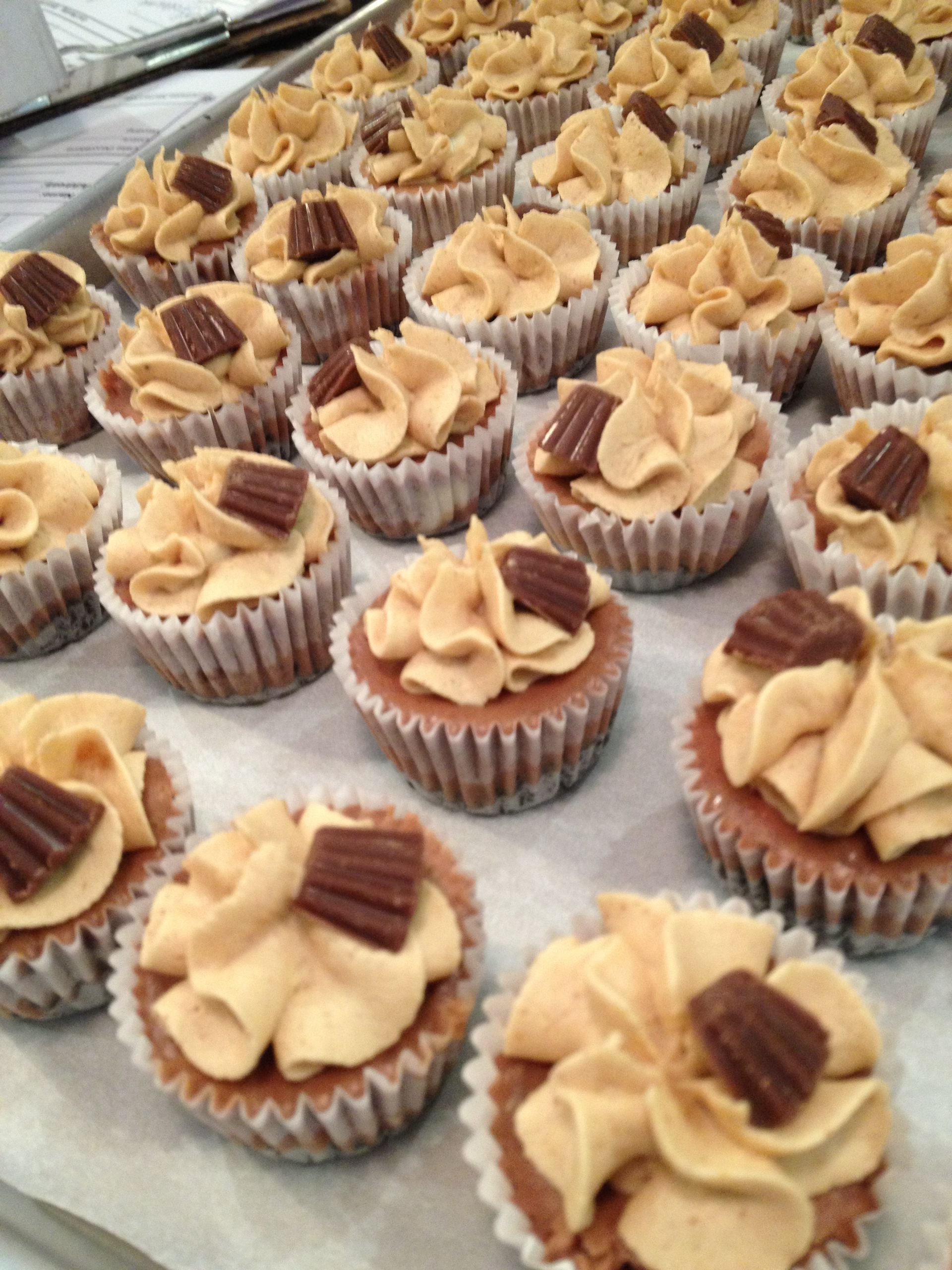 a bunch of cupcakes with peanut butter frosting on them