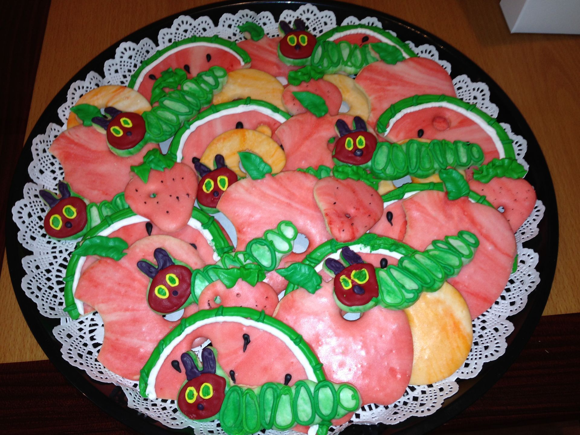 a plate of very hungry caterpillar cookies on a table