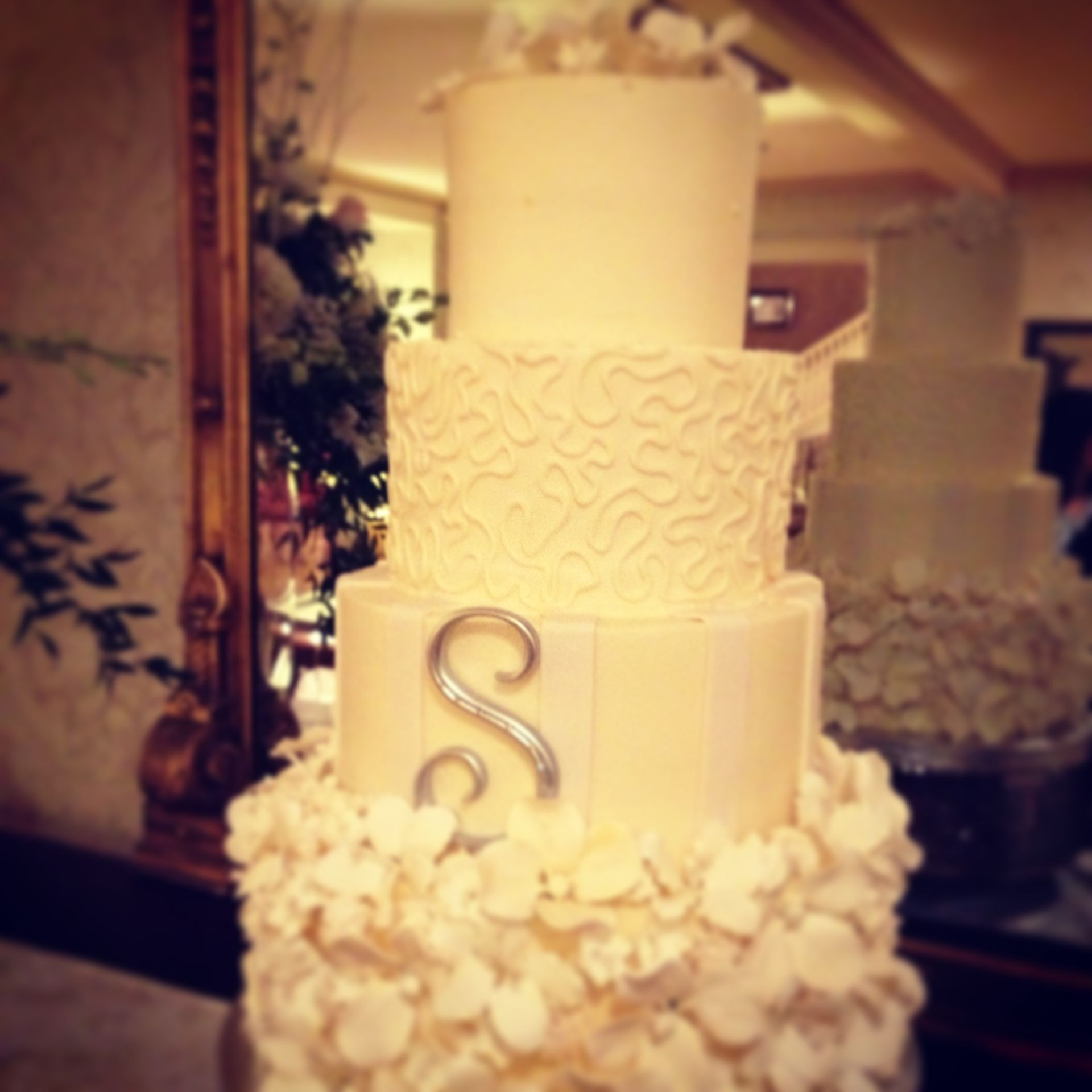 a wedding cake with the letter s on it