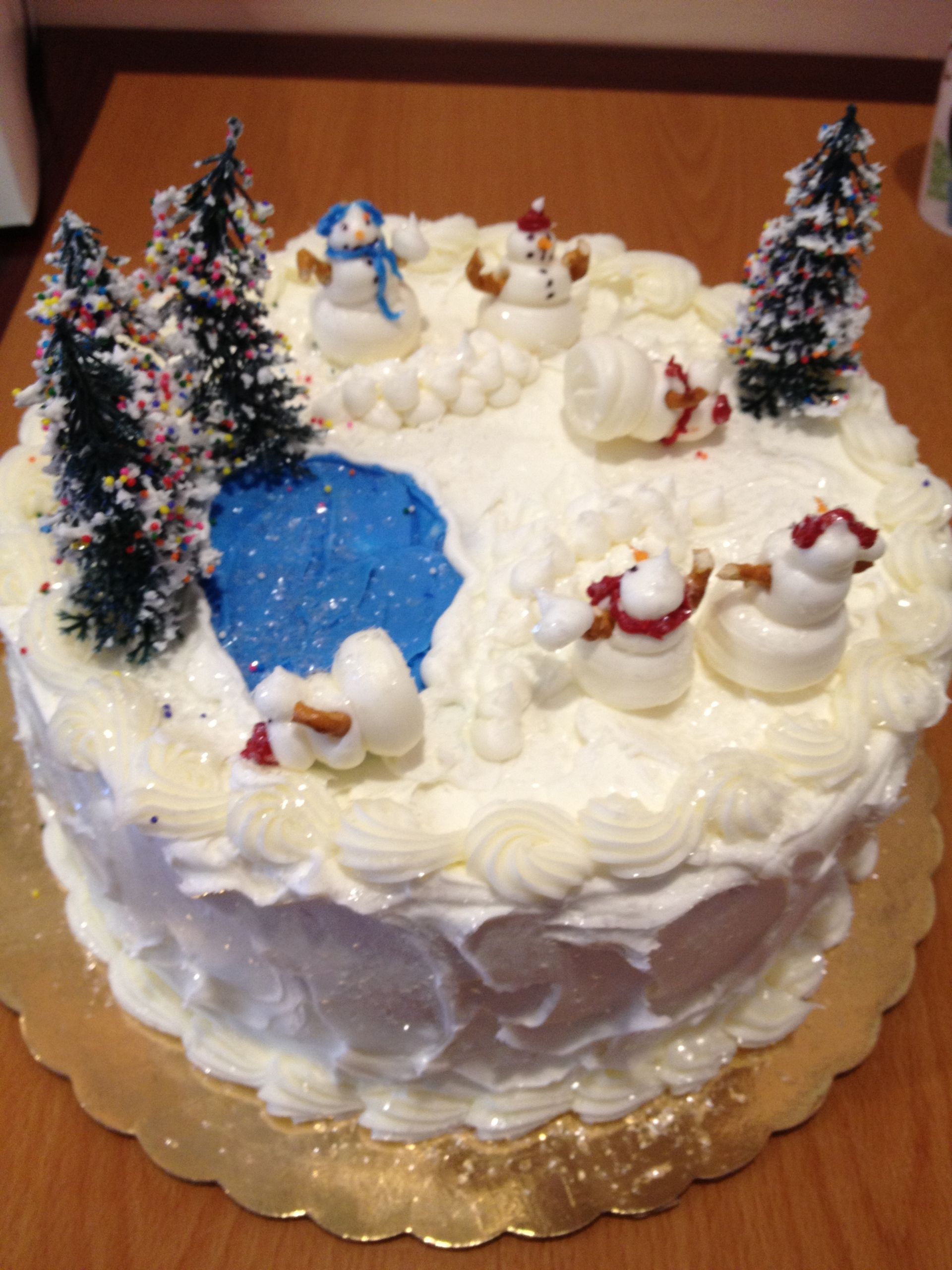 a cake with snowmen and trees on it