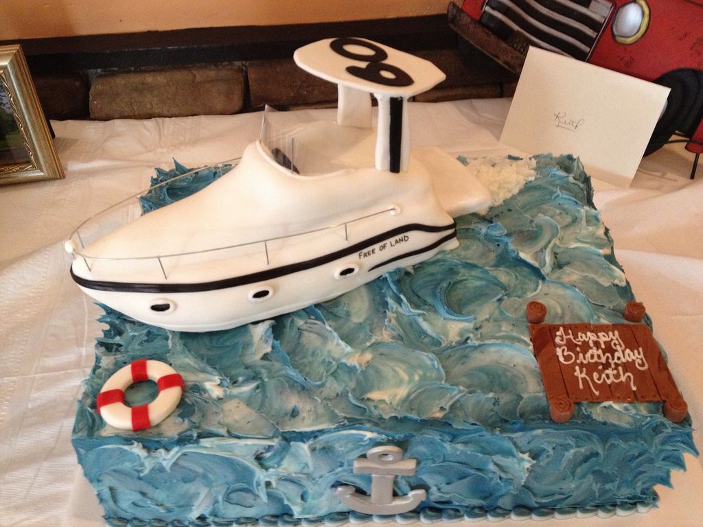 a birthday cake with a boat on top of it
