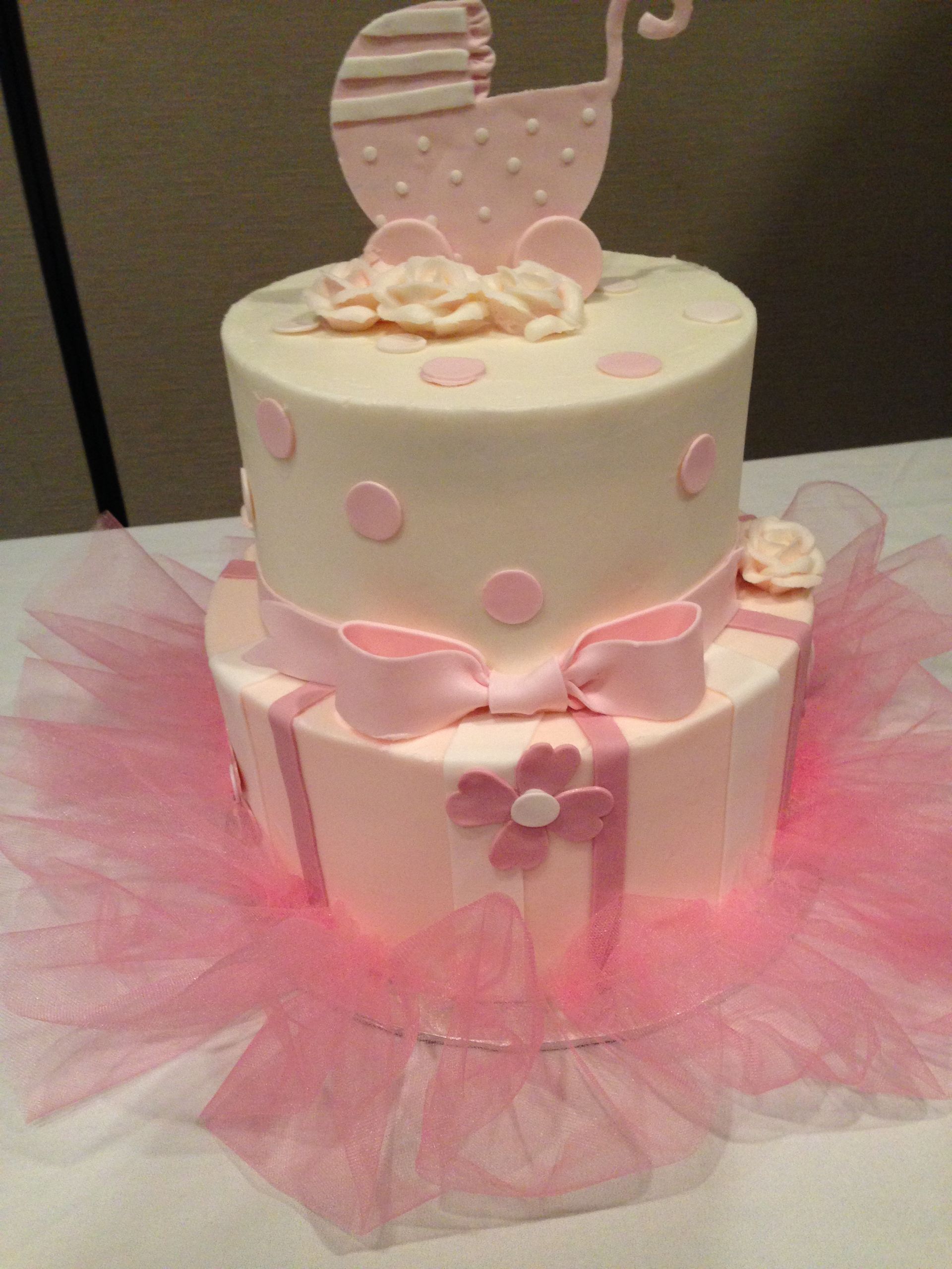 a baby shower cake with a pink stroller on top