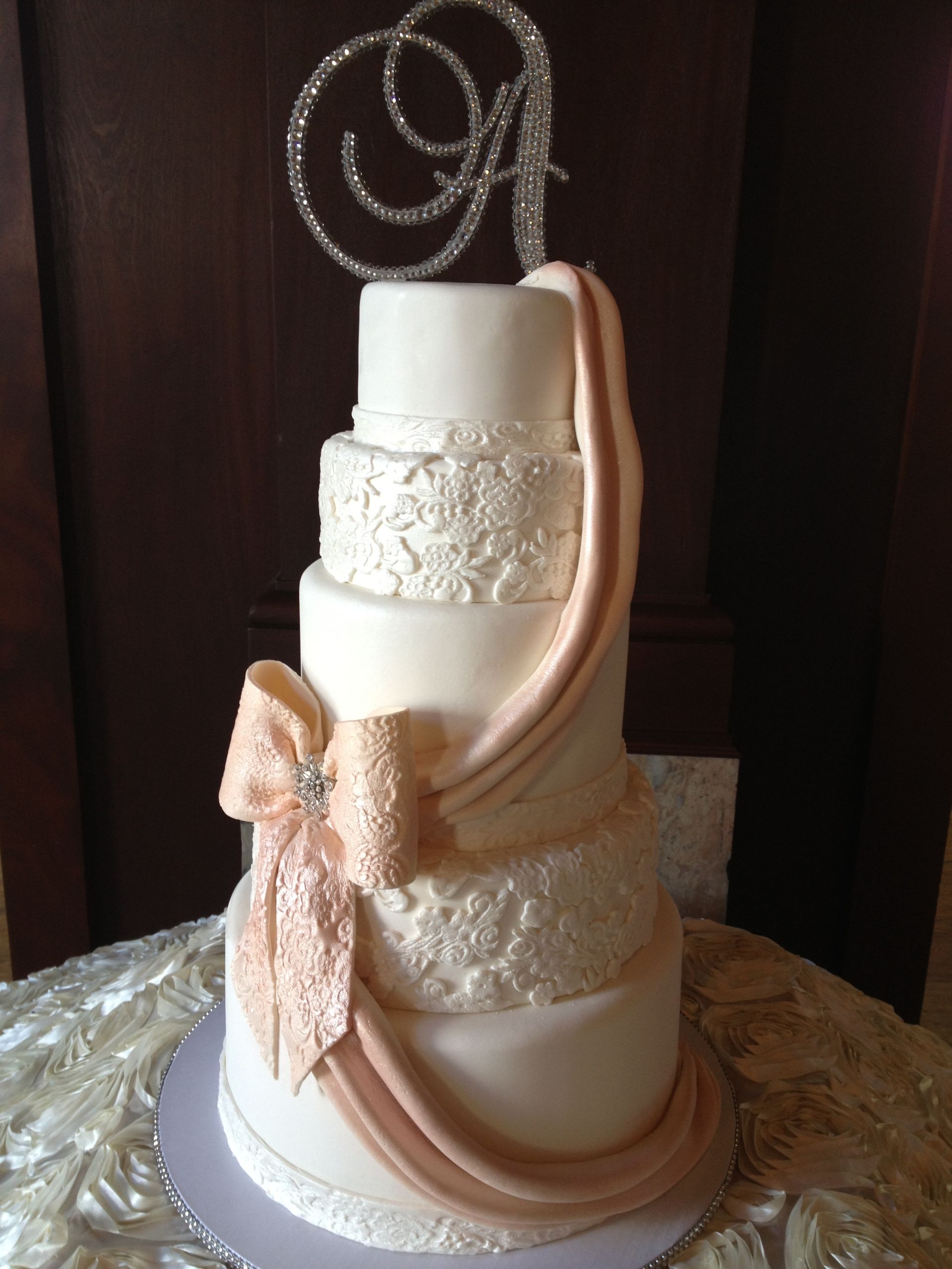 a wedding cake with the letter a on top