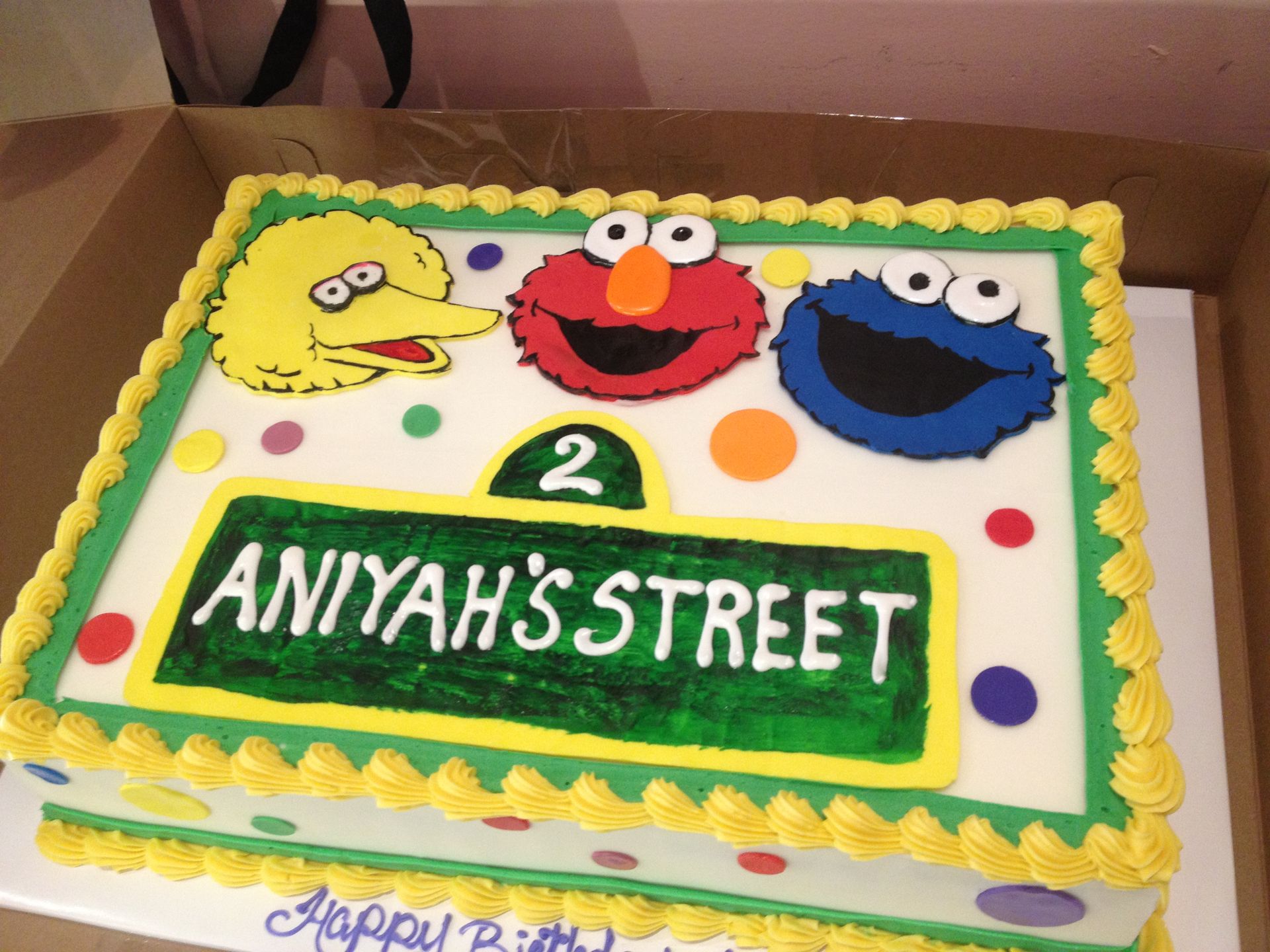 a birthday cake with sesame street characters on it