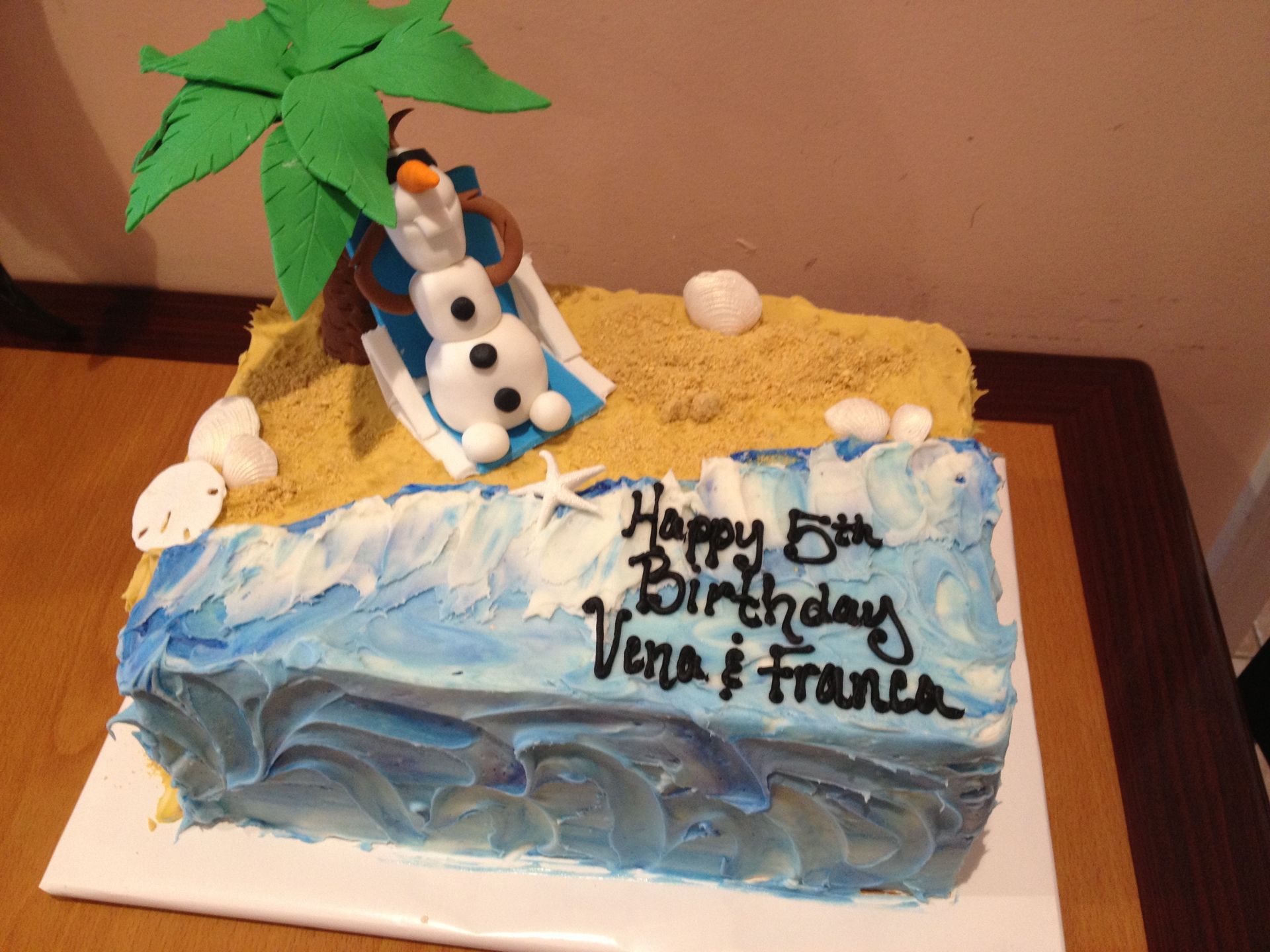 a birthday cake with a snowman on a surfboard