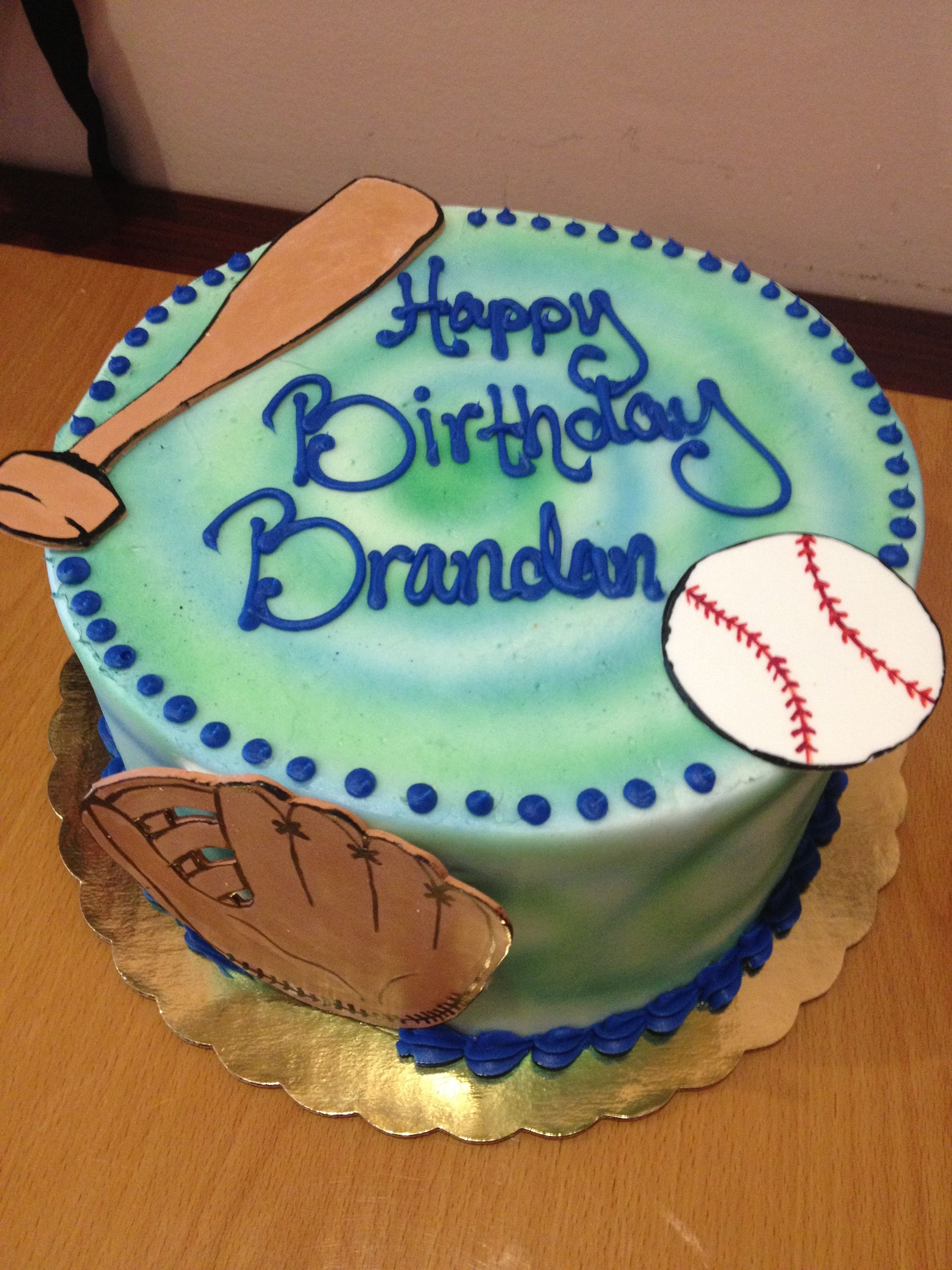 a birthday cake for brandon with a baseball bat and glove